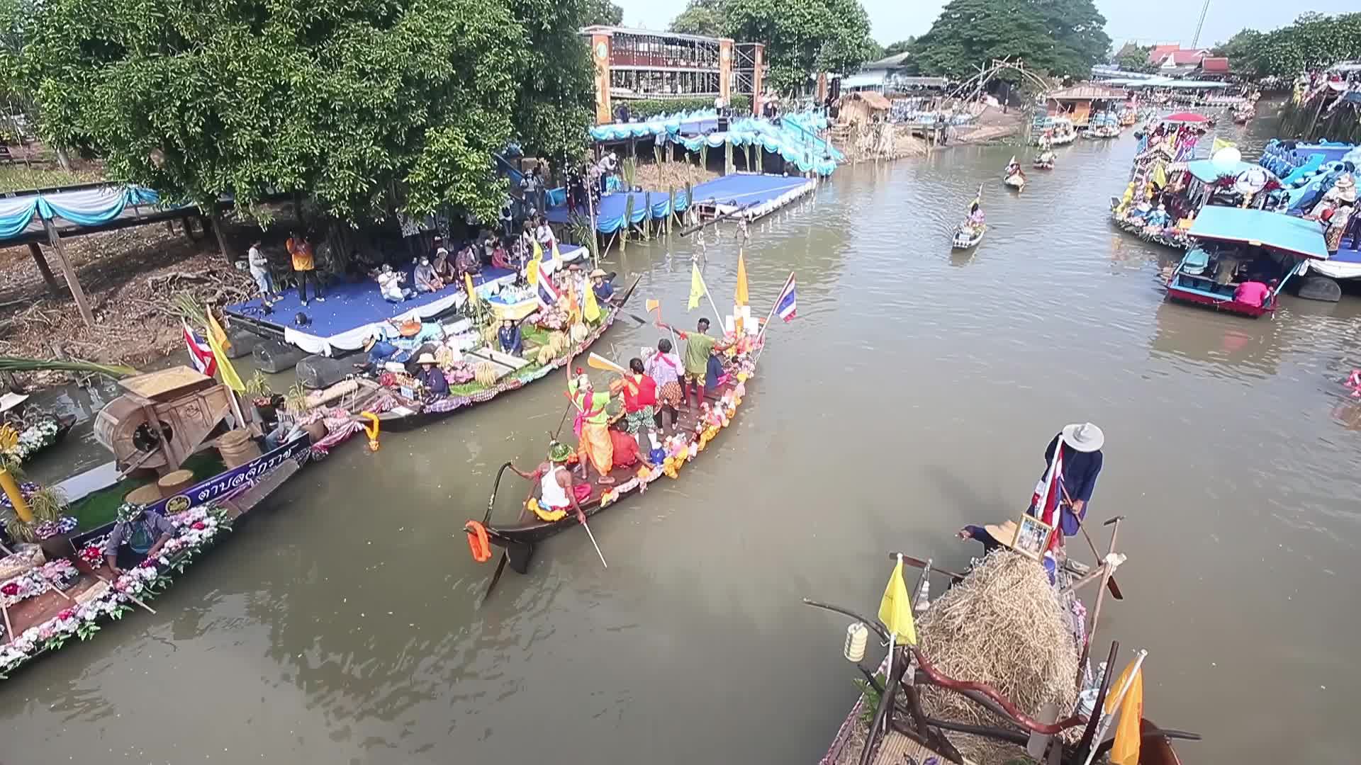 Boats carrying wax castles move along the Lat Chado canal