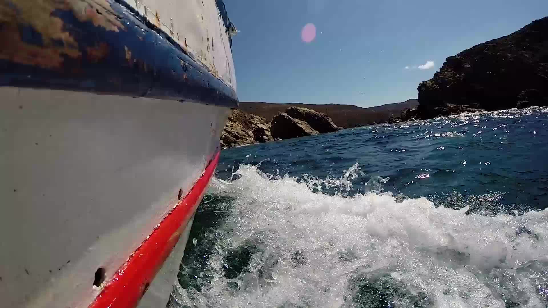 Small boat sailing point of view in a Greek Island