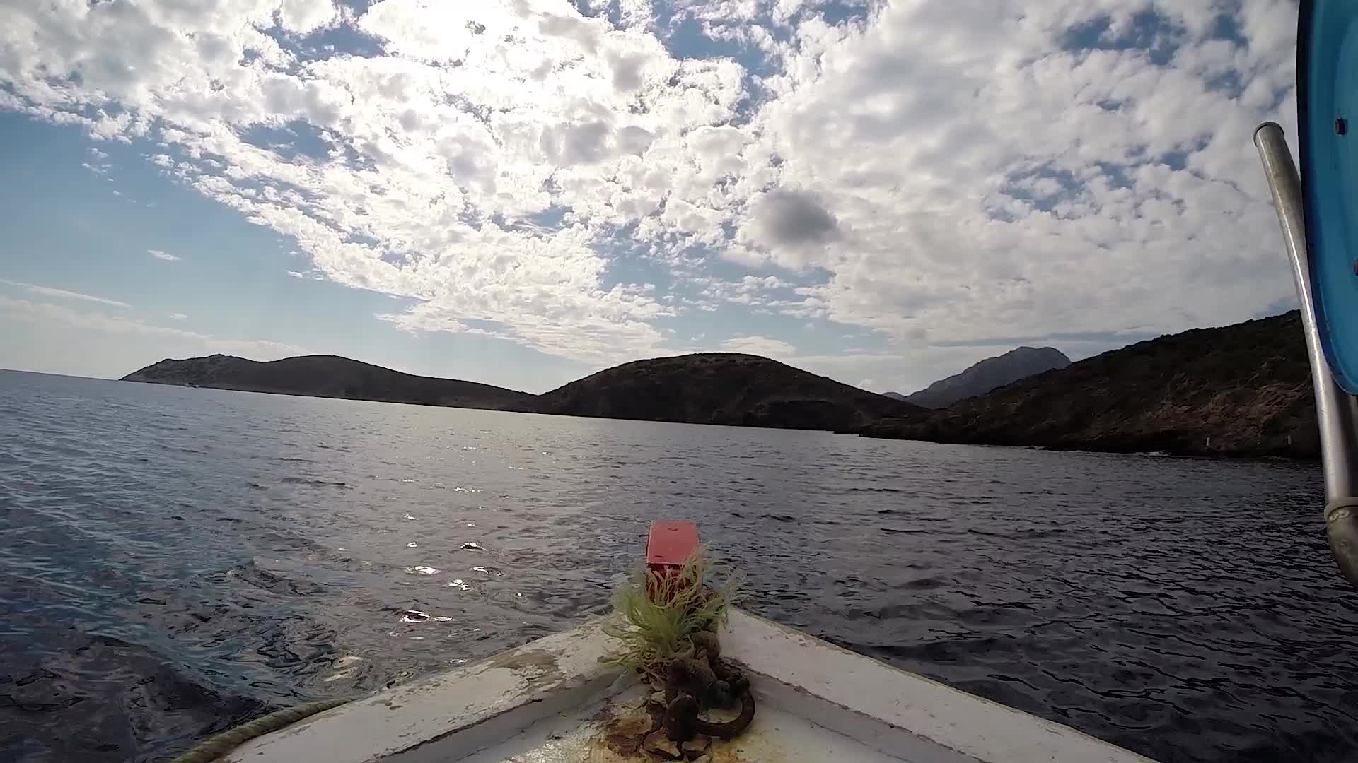 Small boat sailing point of view in a Greek Island