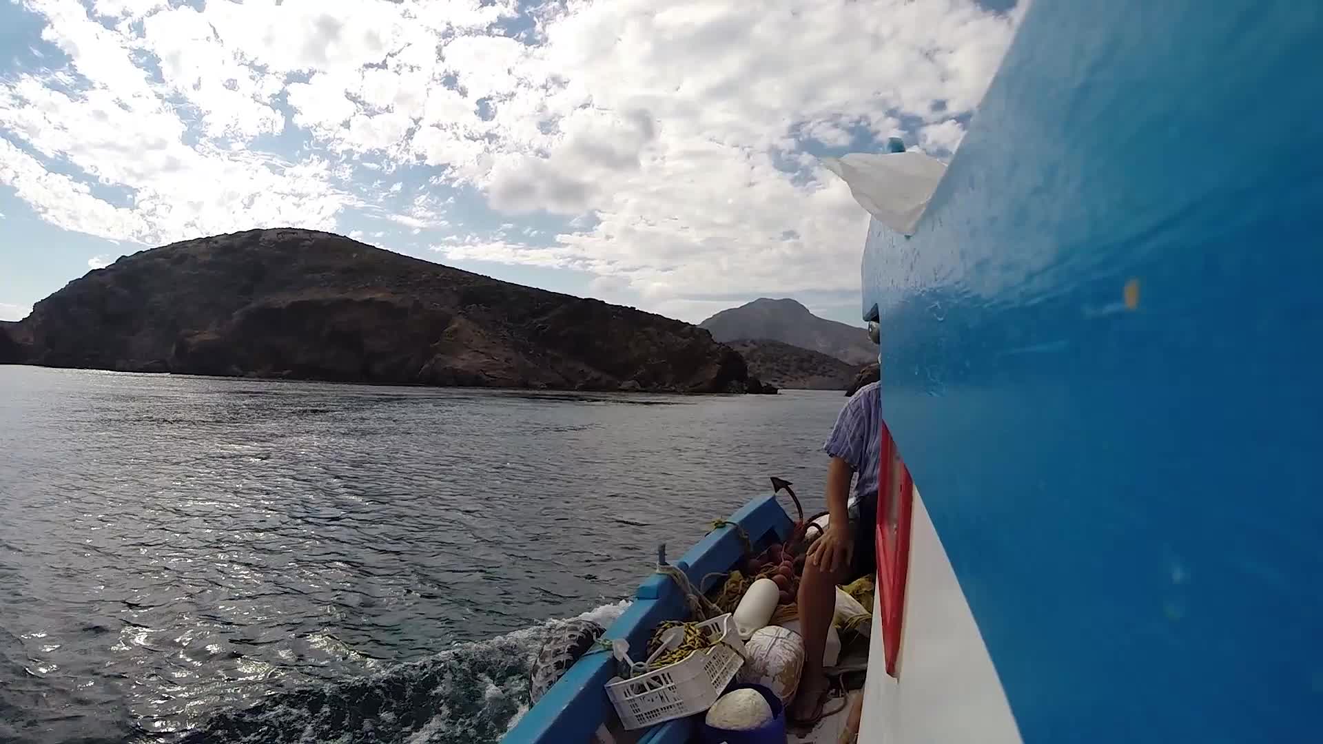 Small boat sailing point of view in a Greek Island