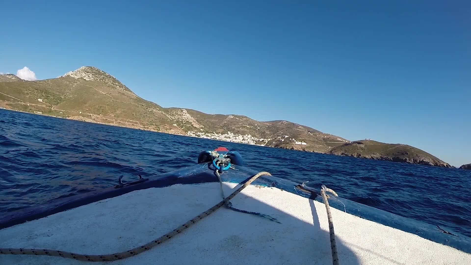 Small boat sailing point of view in a Greek Island