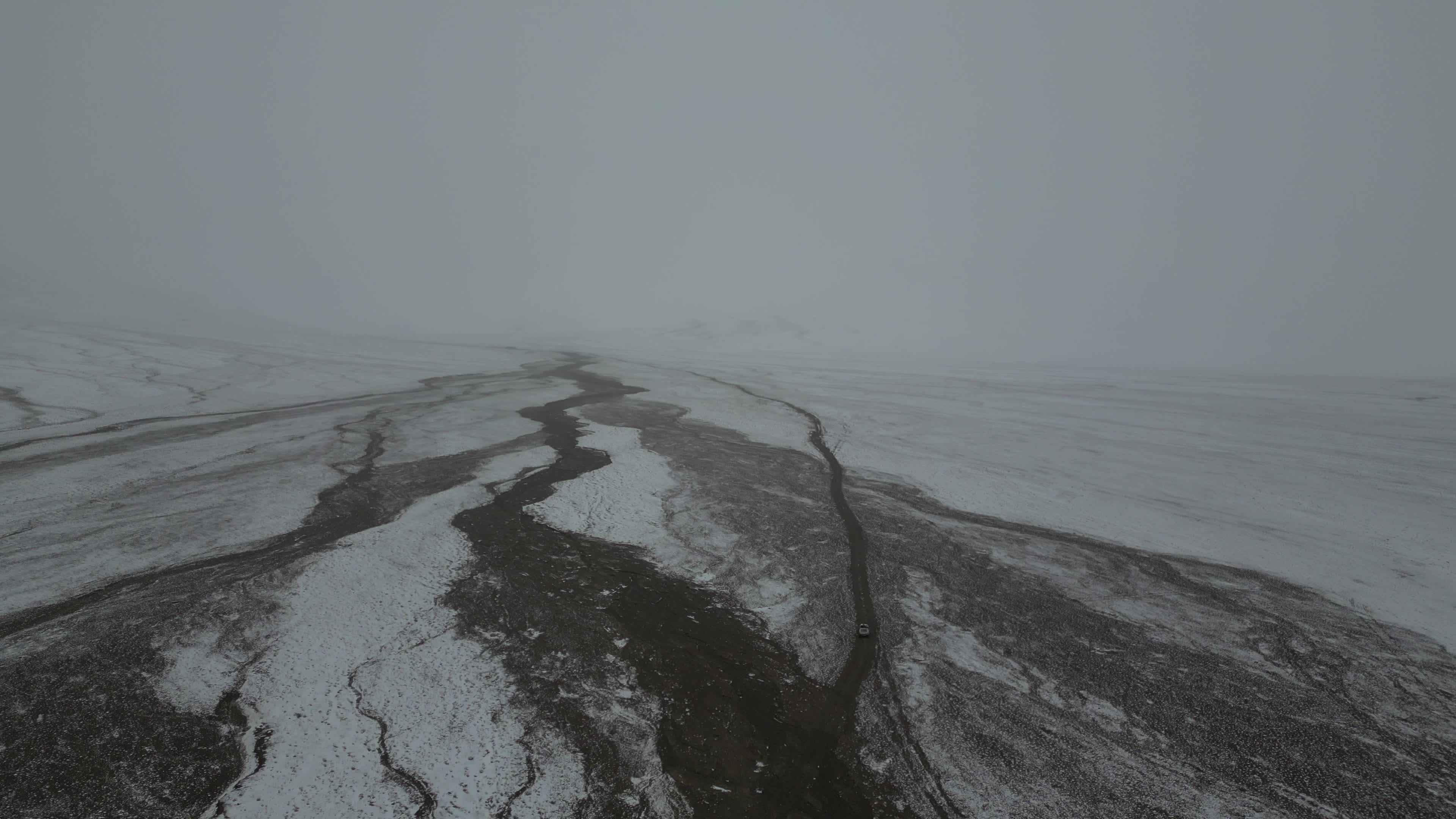 Car driving in the desolate landscape of Tajikistan