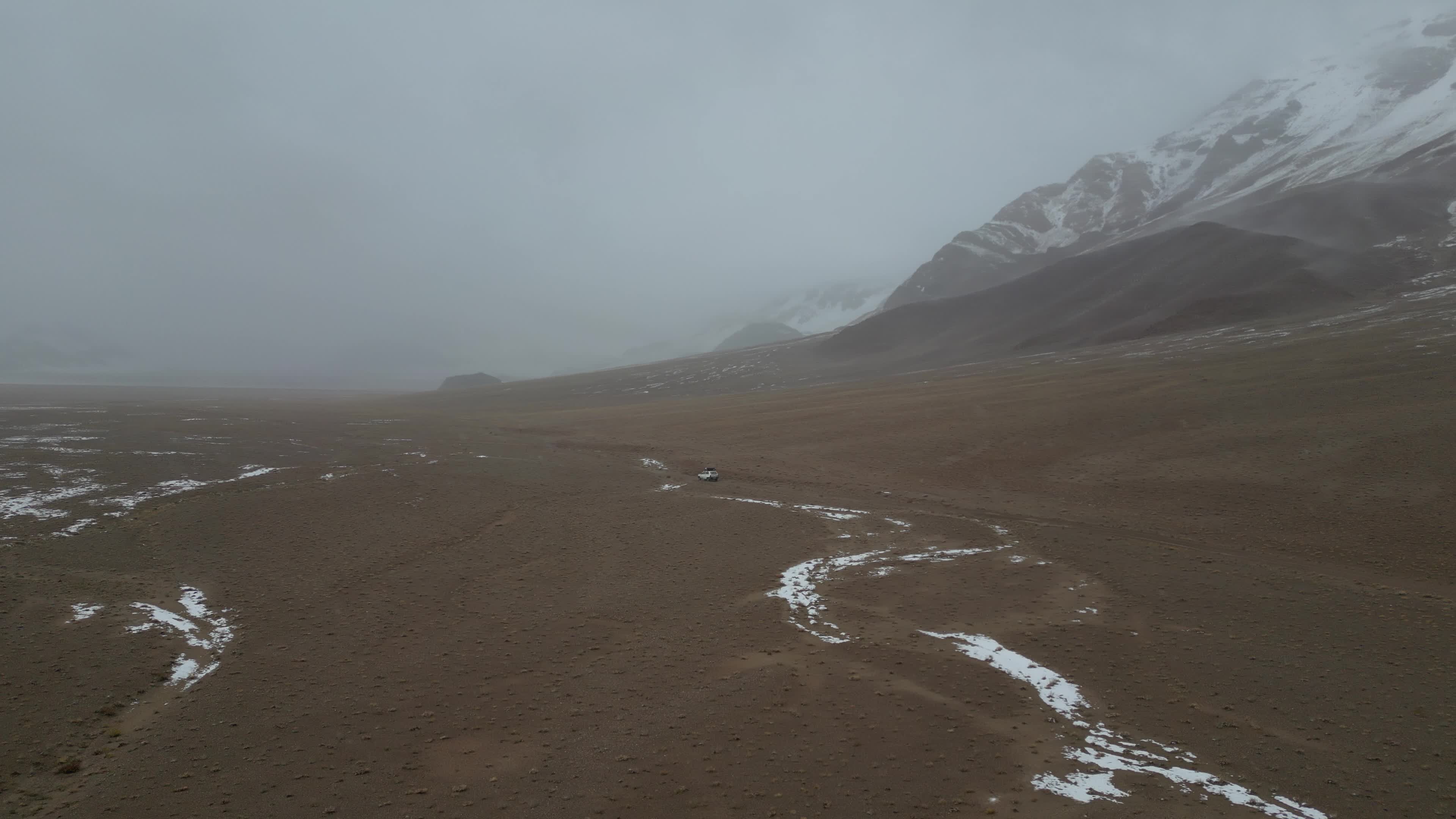 Car driving in the desolate landscape of Tajikistan