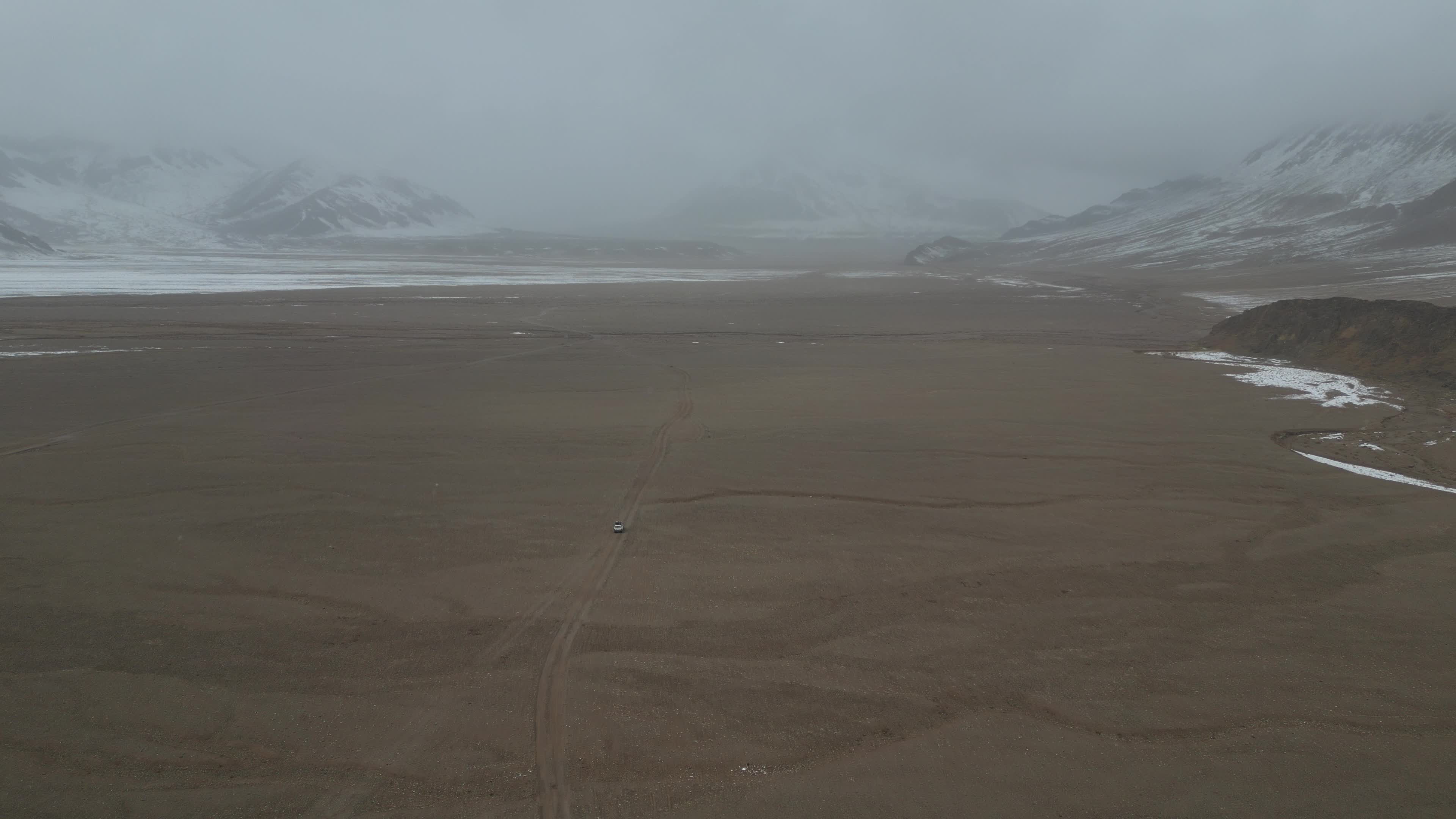 Car driving in the desolate landscape of Tajikistan