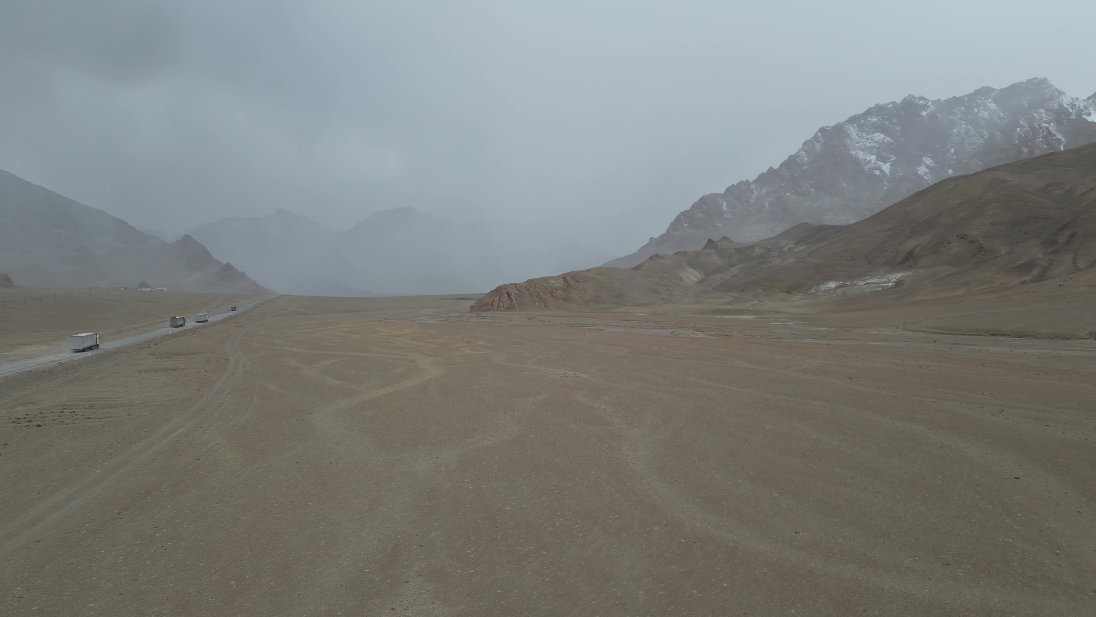 Drone videos of trucks driving on the Pamir Highway