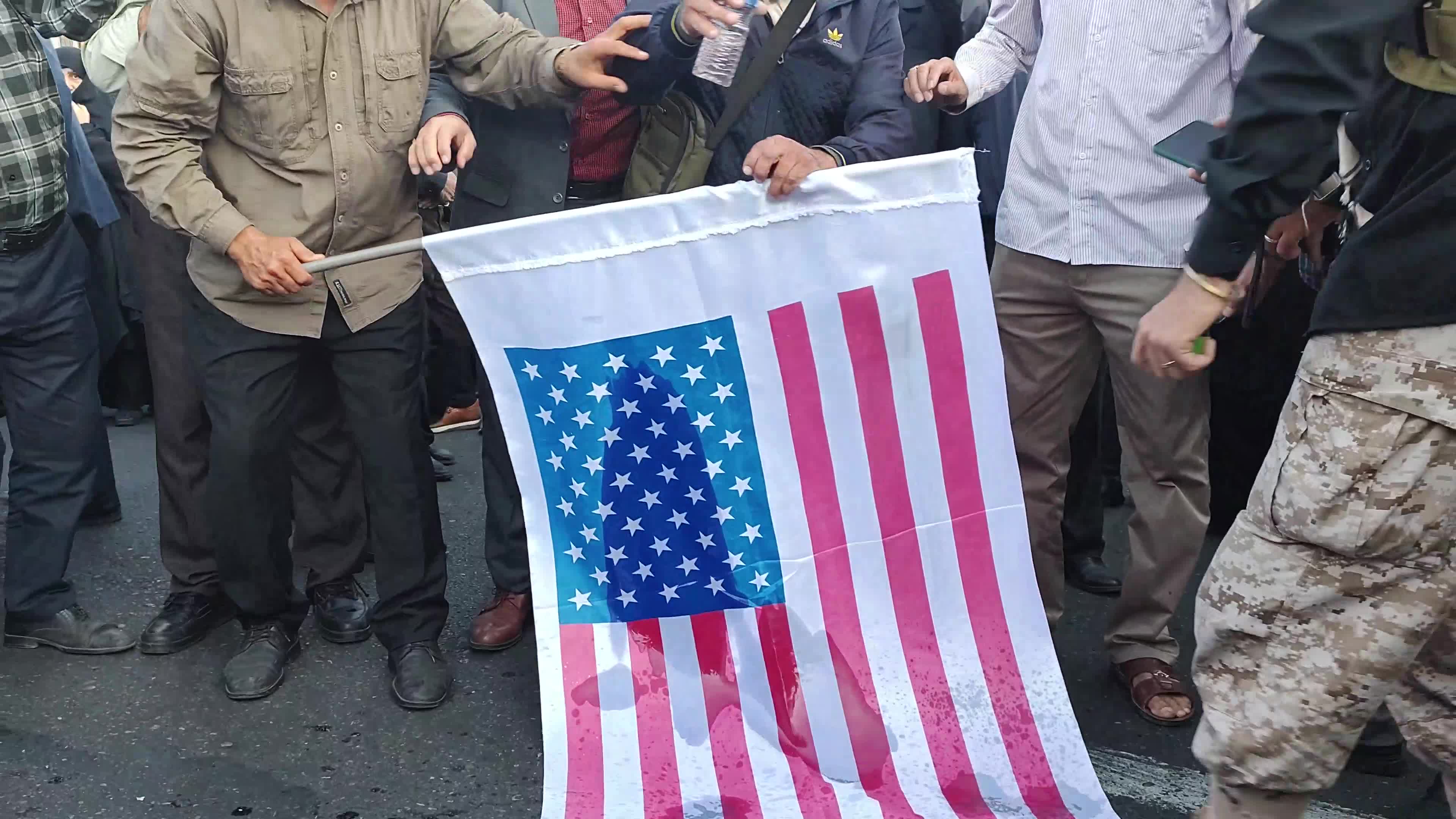 Burning U.S. and Israel flags in an anti-Israel Rally in Tehran