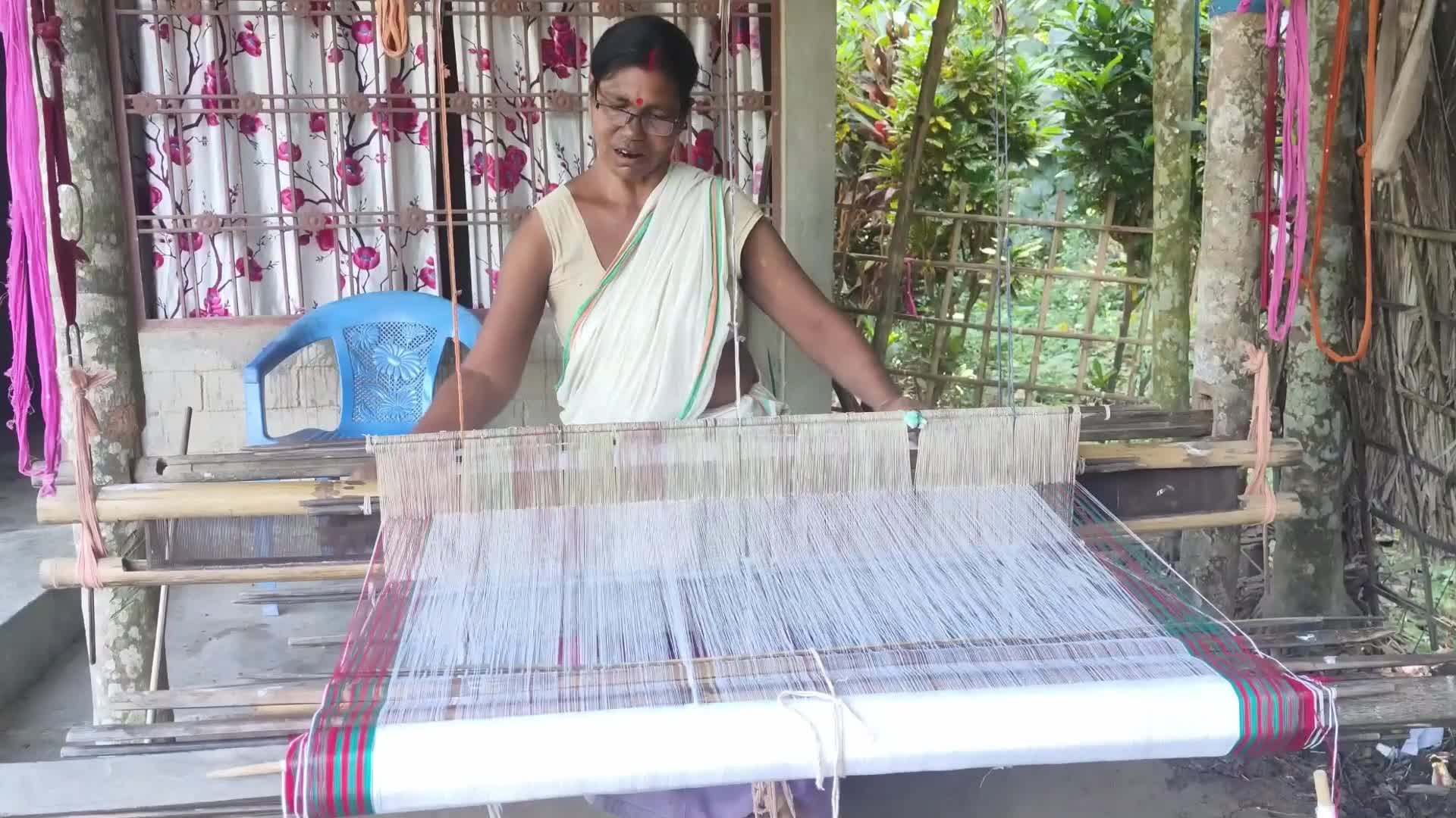 Woman works on handloom in India