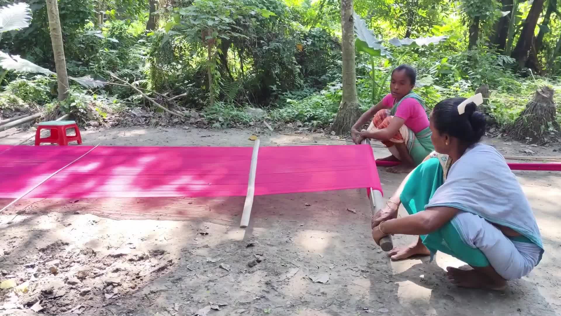 Woman works on handloom in India