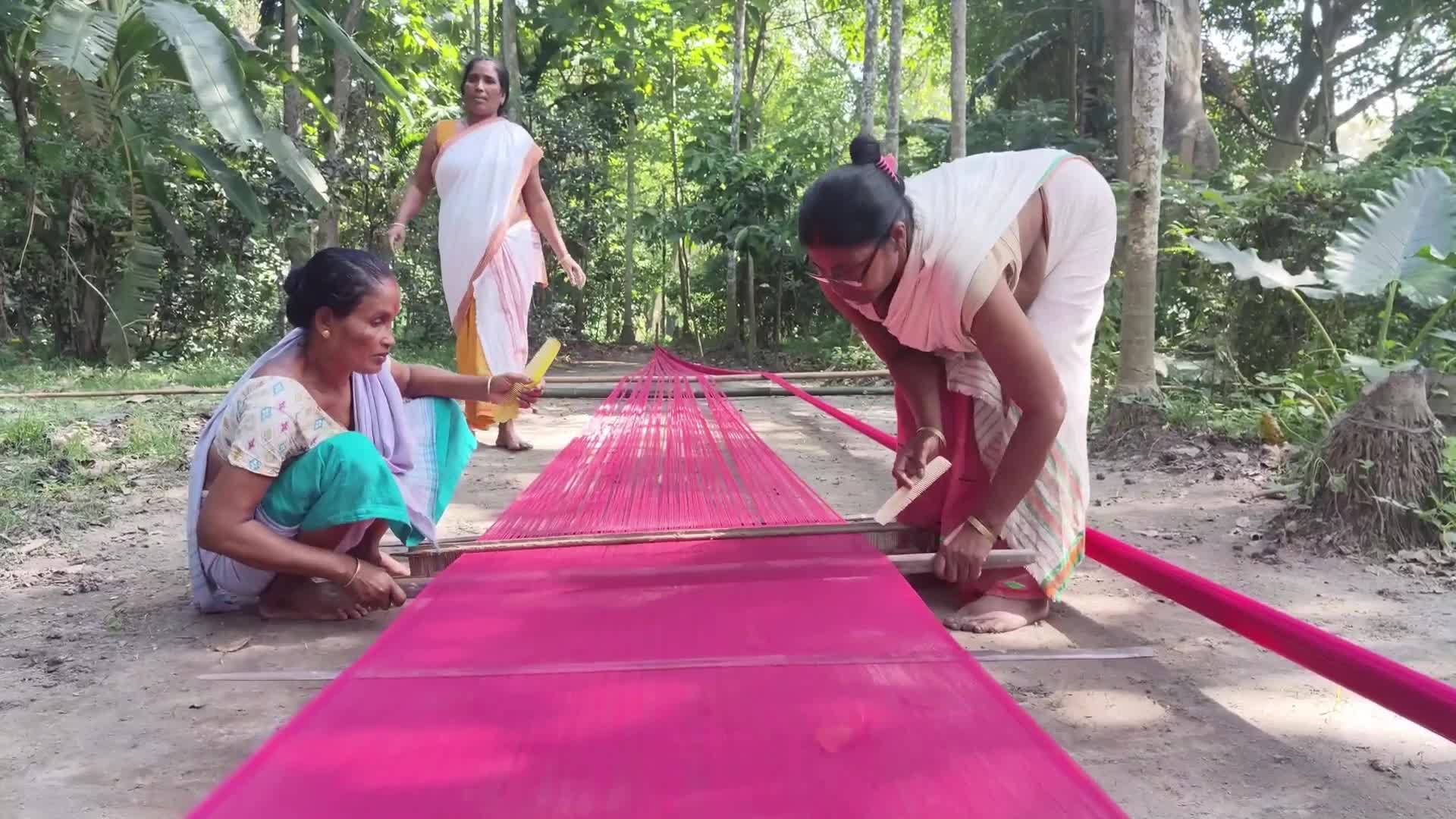 Woman works on handloom in India