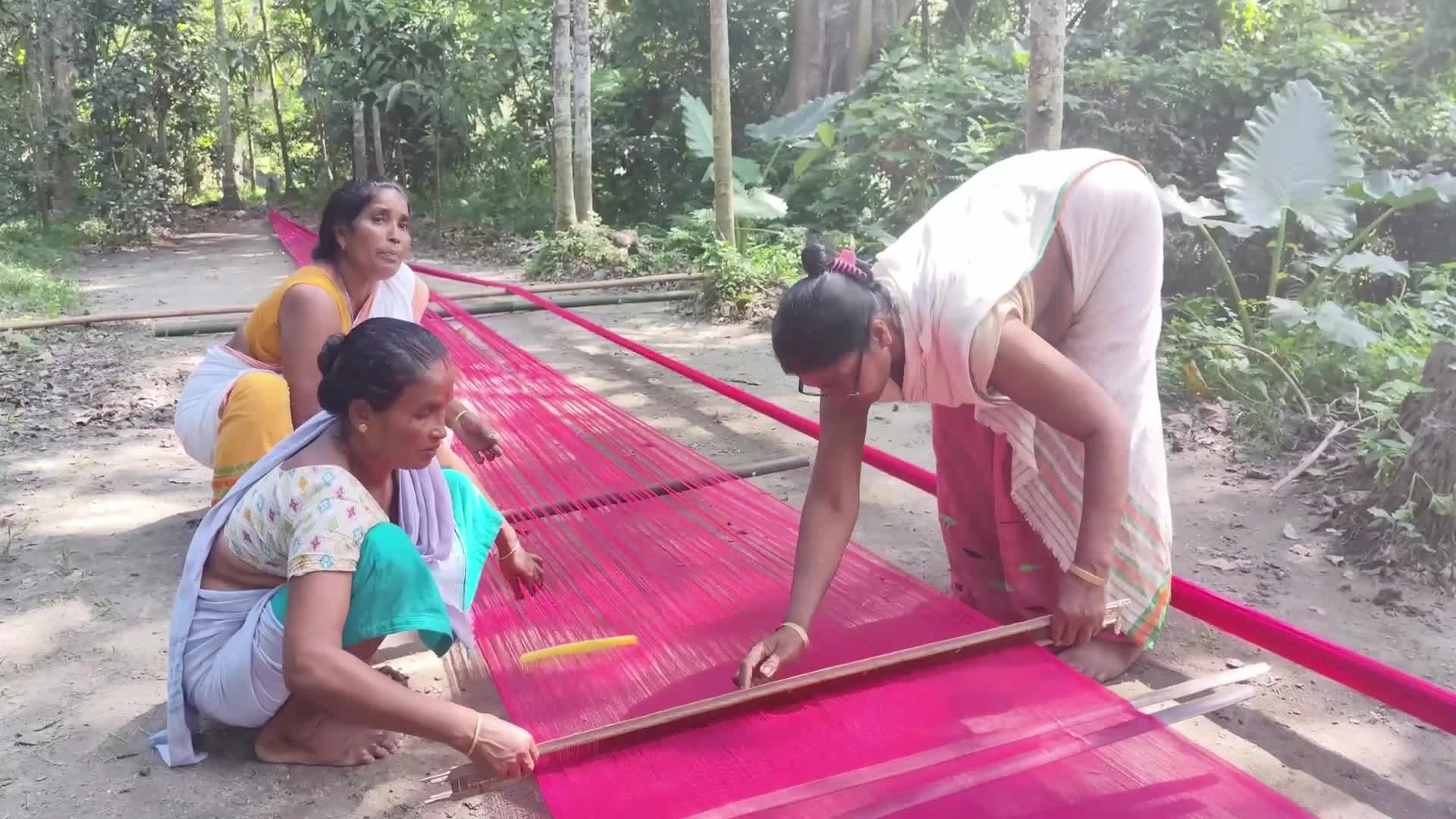 Woman works on handloom in India