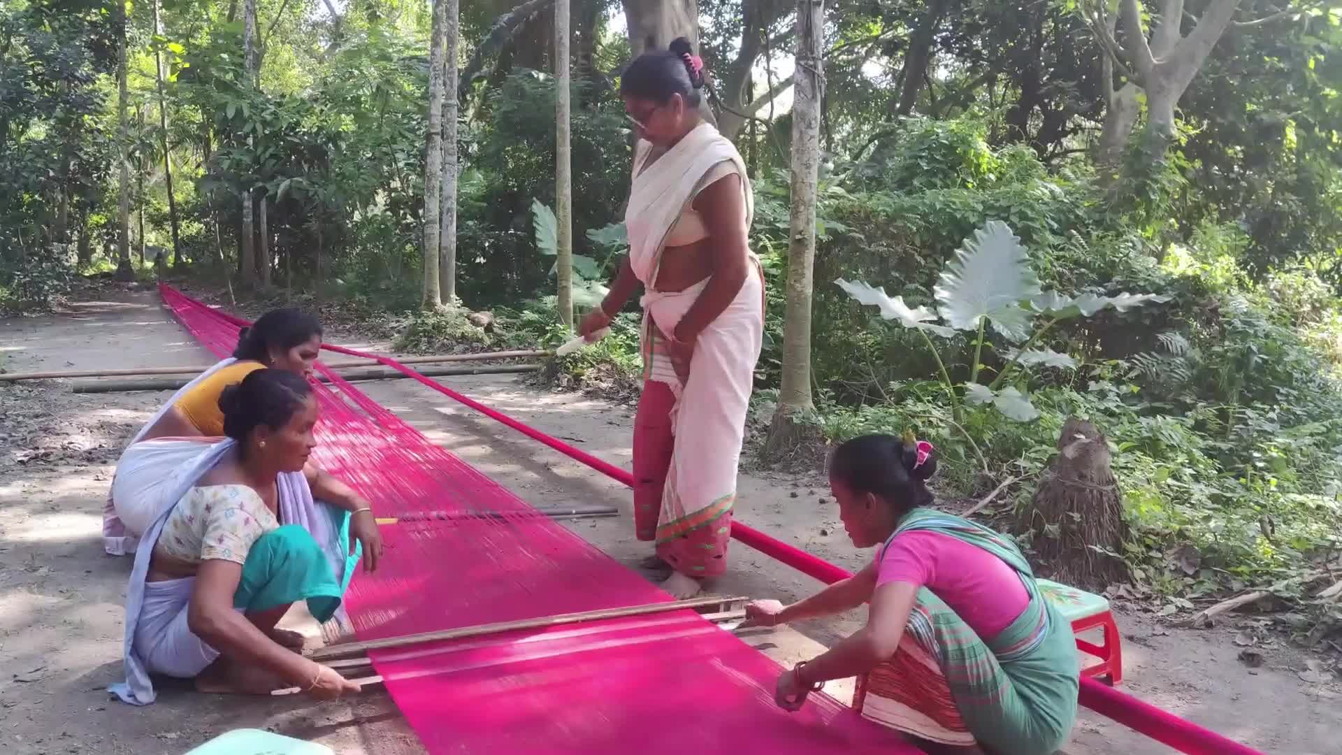 Woman works on handloom in India