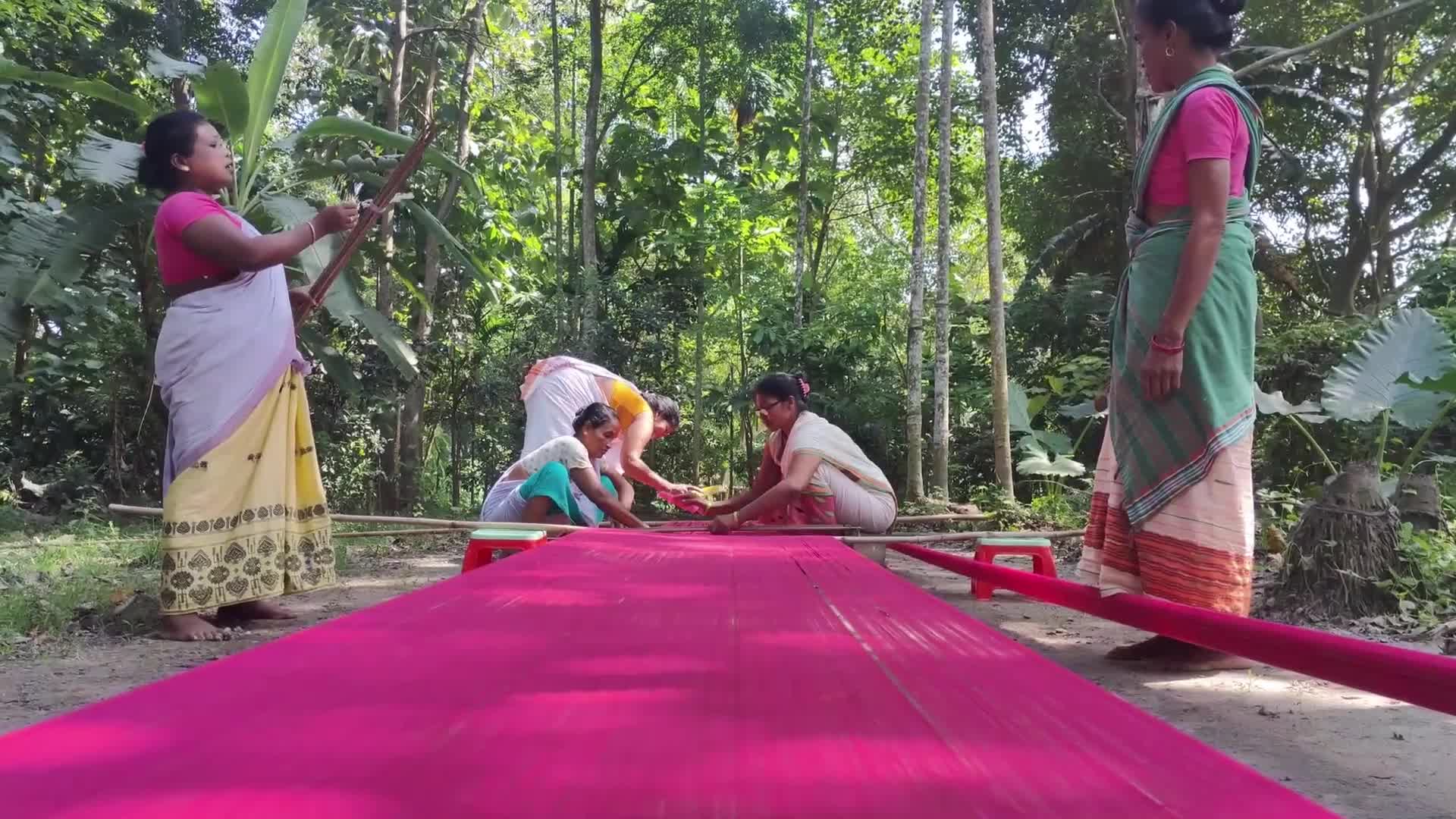 Woman works on handloom in India