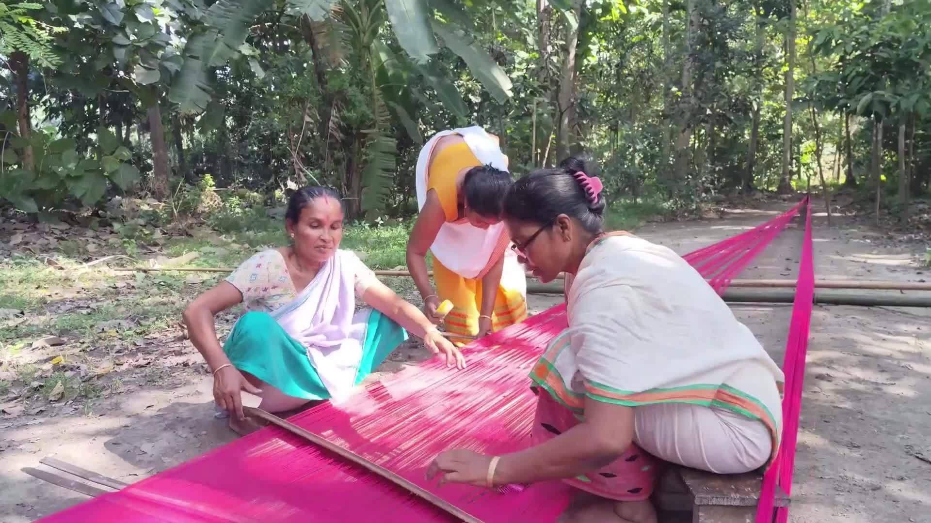 Woman works on handloom in India