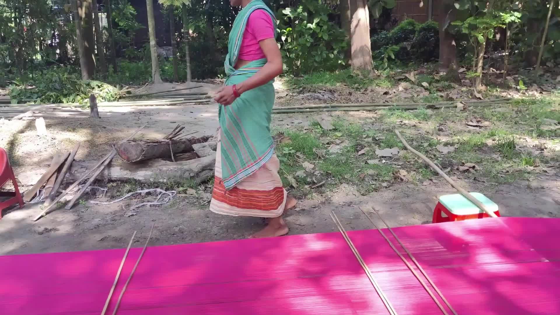 Woman works on handloom in India