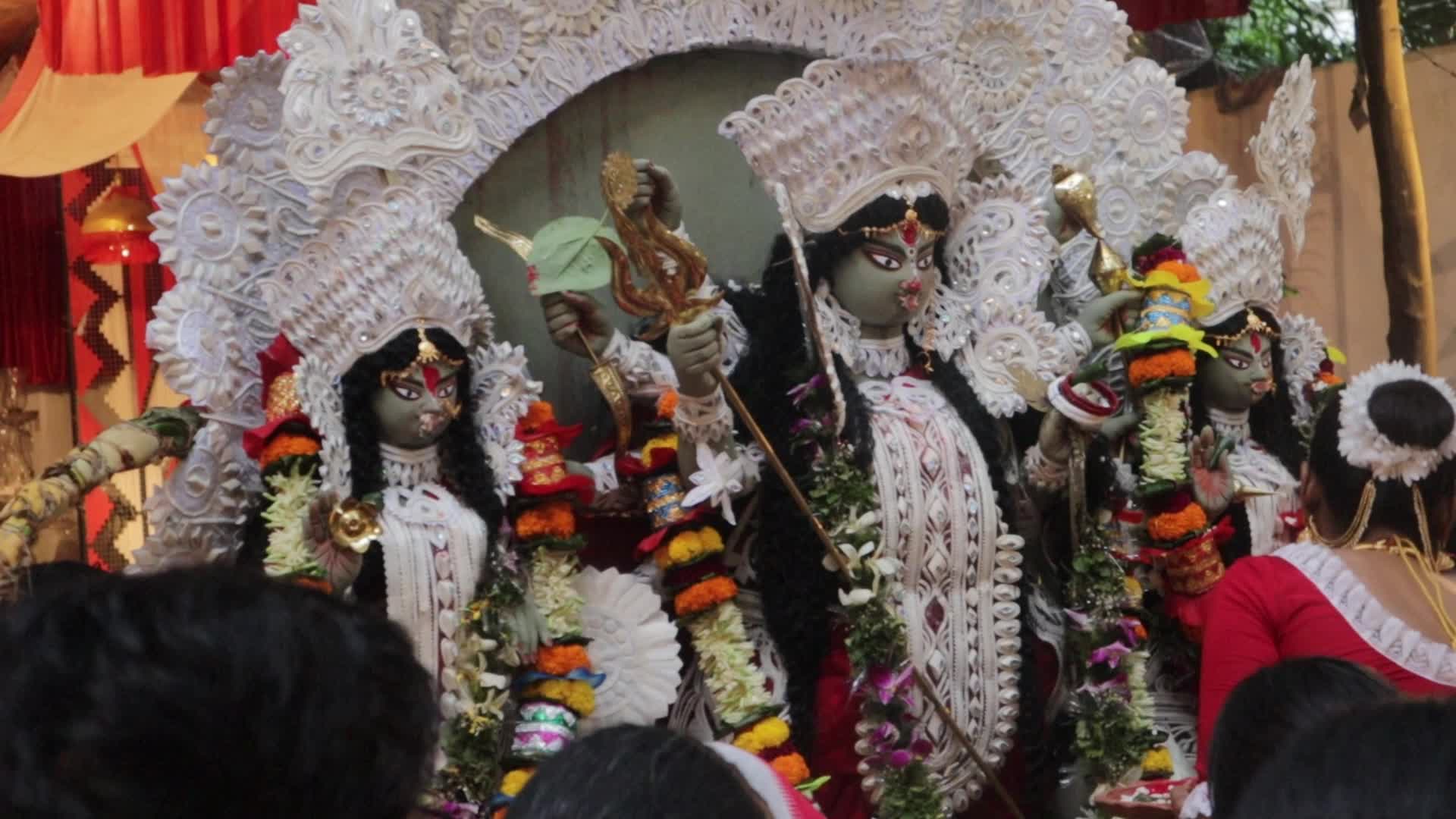 Woman performs rituals just before the immersion of Durga idol 