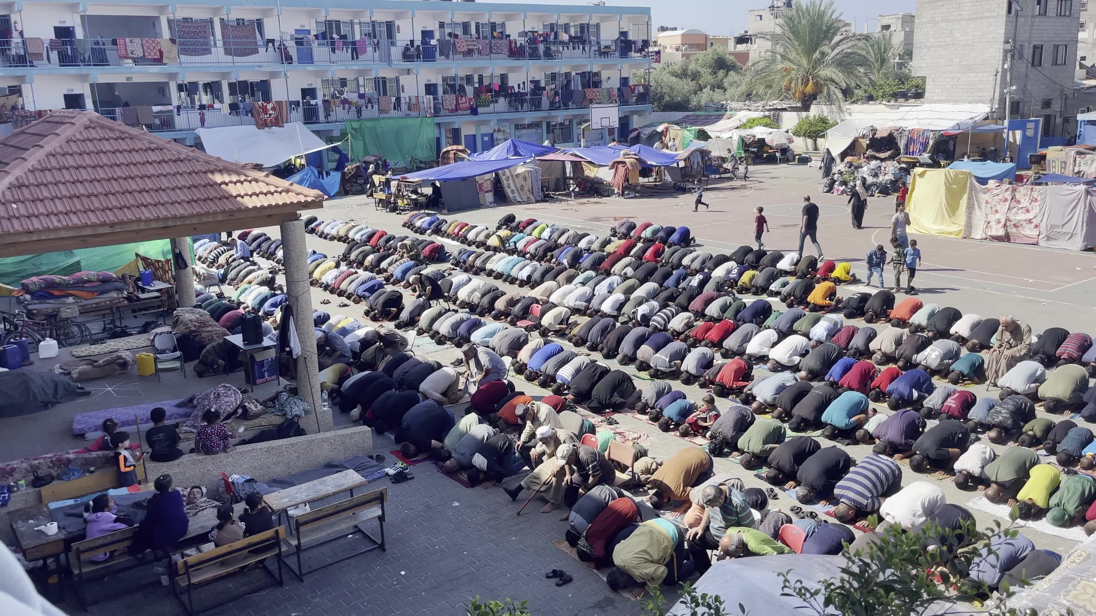 Displaced Palestinians Pray at UNRWA School in Khan Yunis Amid Conflict Between Hamas and Israel