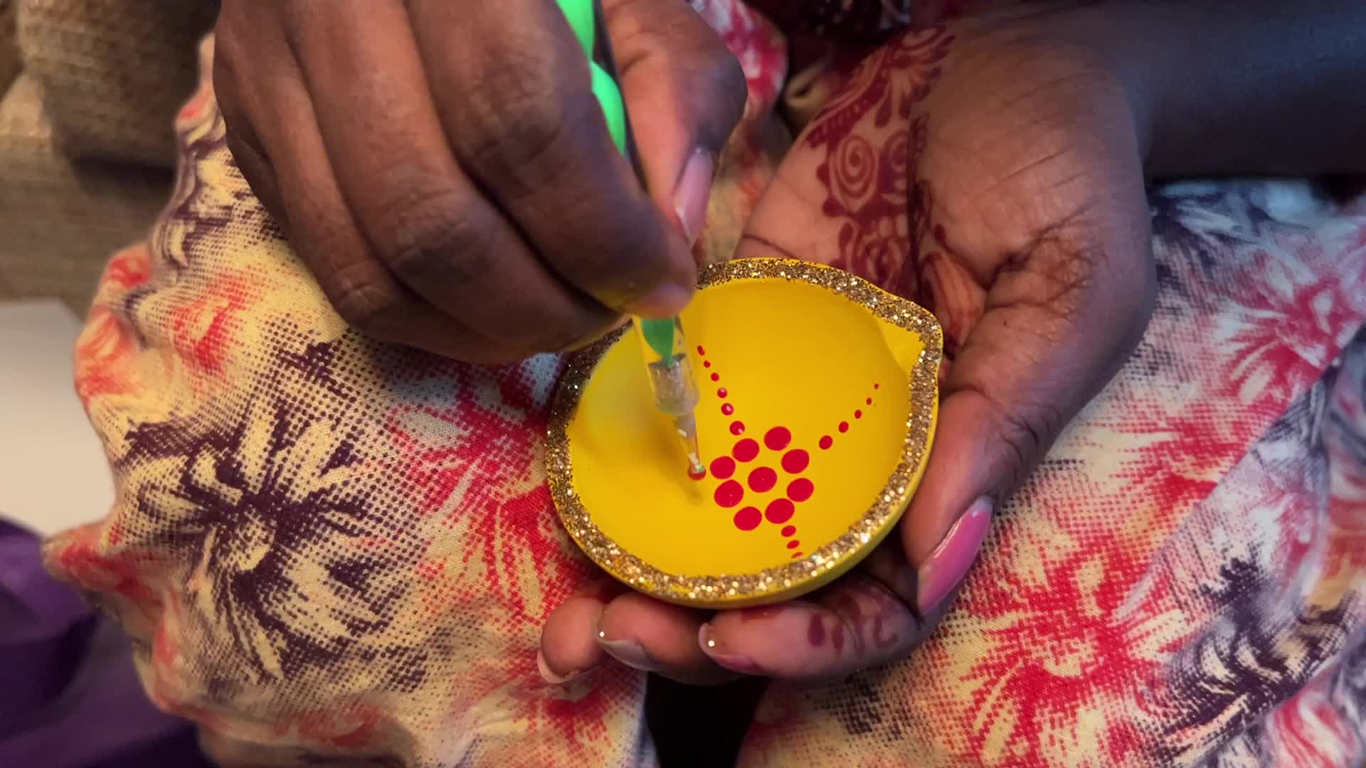 Decorating clay Diwali diyas in preparation for the Diwali festival