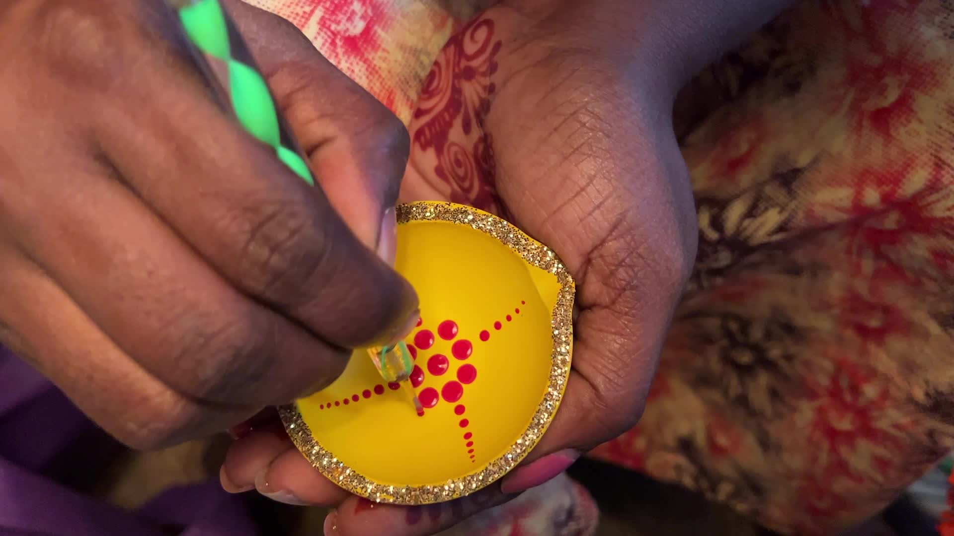 Decorating clay Diwali diyas in preparation for the Diwali festival