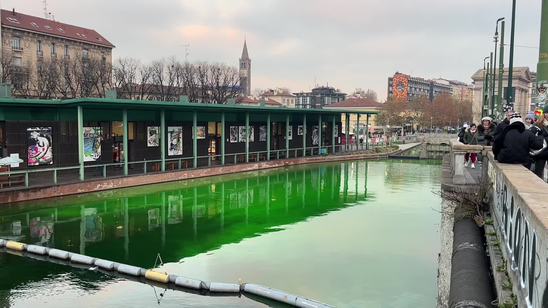 The water of the Darsena colored green by the activists of Extinction Rebellion in Milan