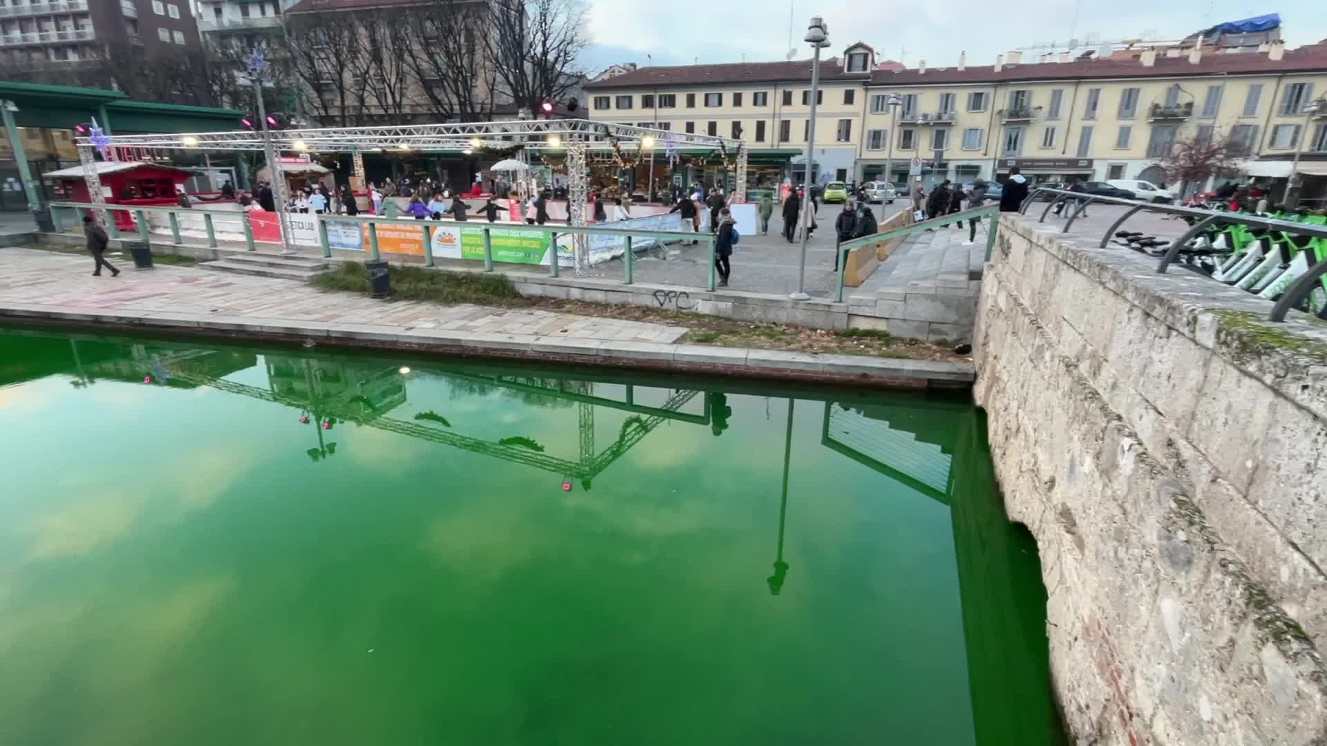 The water of the Darsena colored green by the activists of Extinction Rebellion in Milan