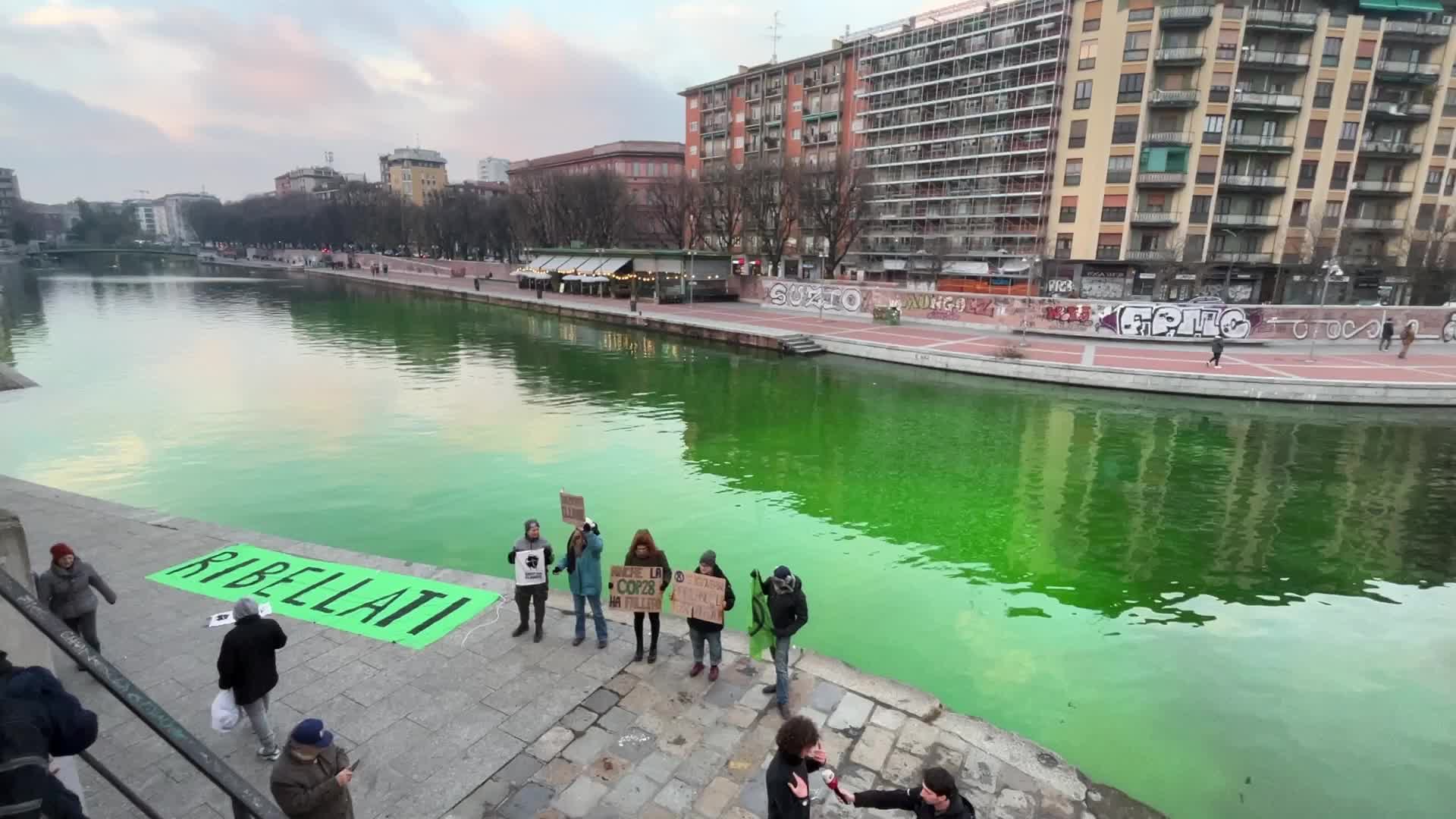 The water of the Darsena colored green by the activists of Extinction Rebellion in Milan
