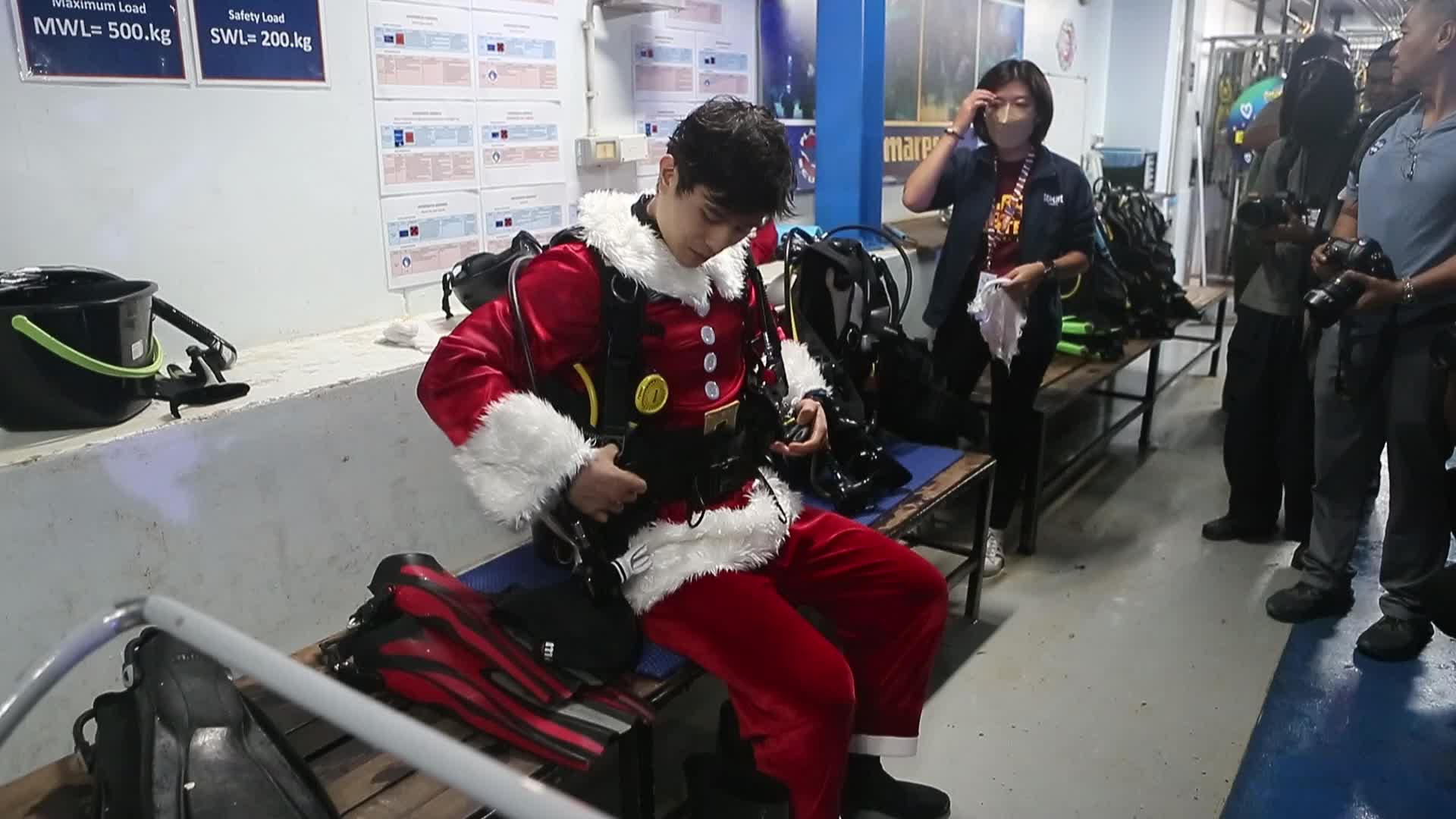 Diver Dressed As Santa Claus Feeds Fish to Celebrate Christmas, in Bangkok