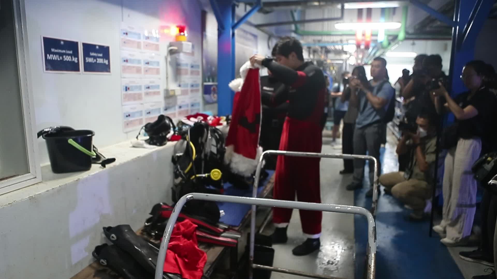 Diver Dressed As Santa Claus Feeds Fish to Celebrate Christmas, in Bangkok