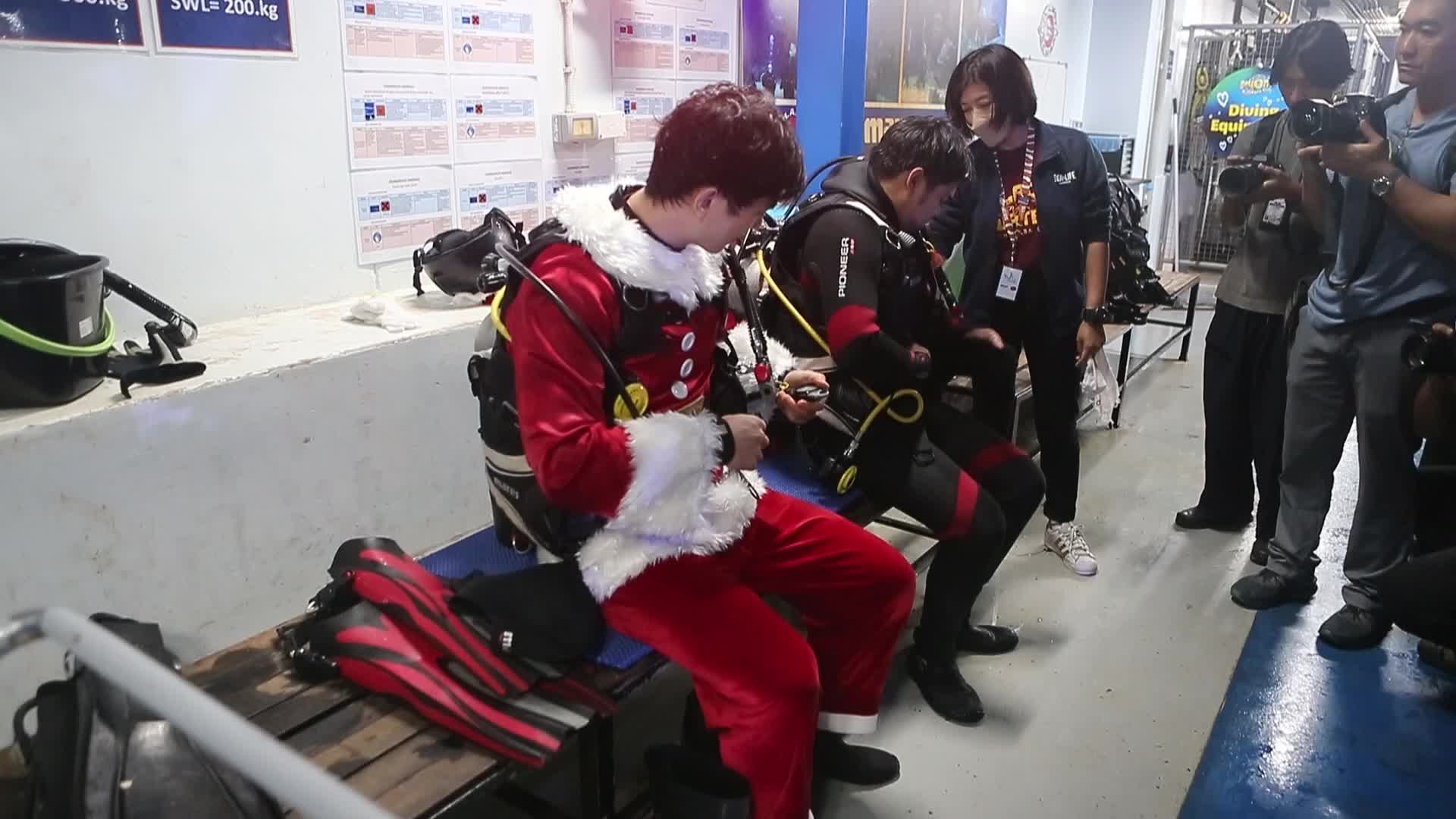 Diver Dressed As Santa Claus Feeds Fish to Celebrate Christmas, in Bangkok