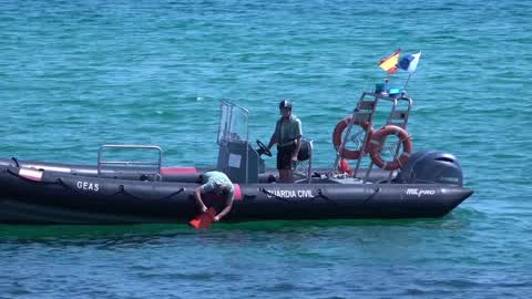 The Spanish Navy investigates possible explosive device on a beach in Barcelona