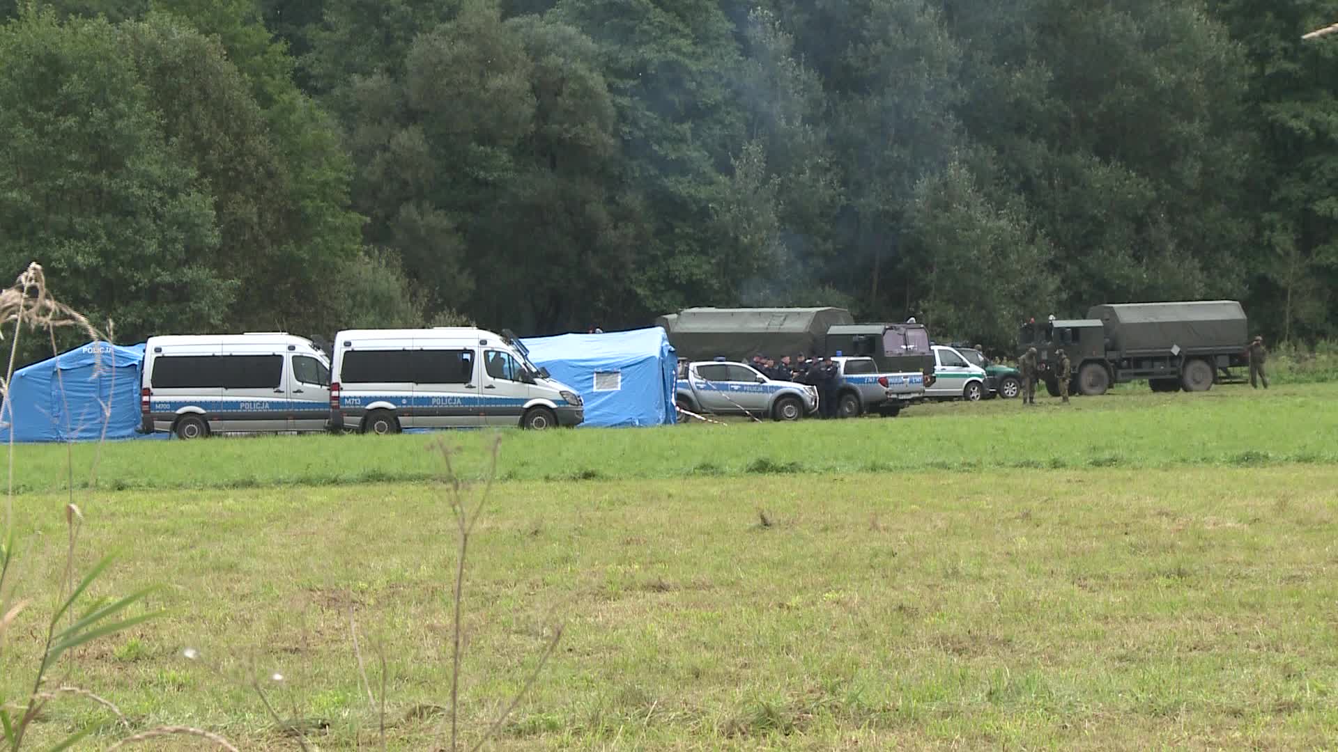 Migrants camp at Polish-Belarusian border guarded by police and military