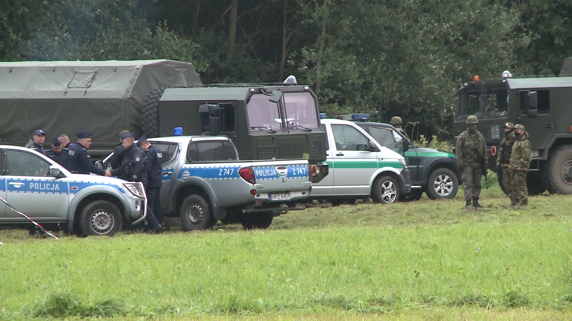 Migrants camp at Polish-Belarusian border guarded by police and military