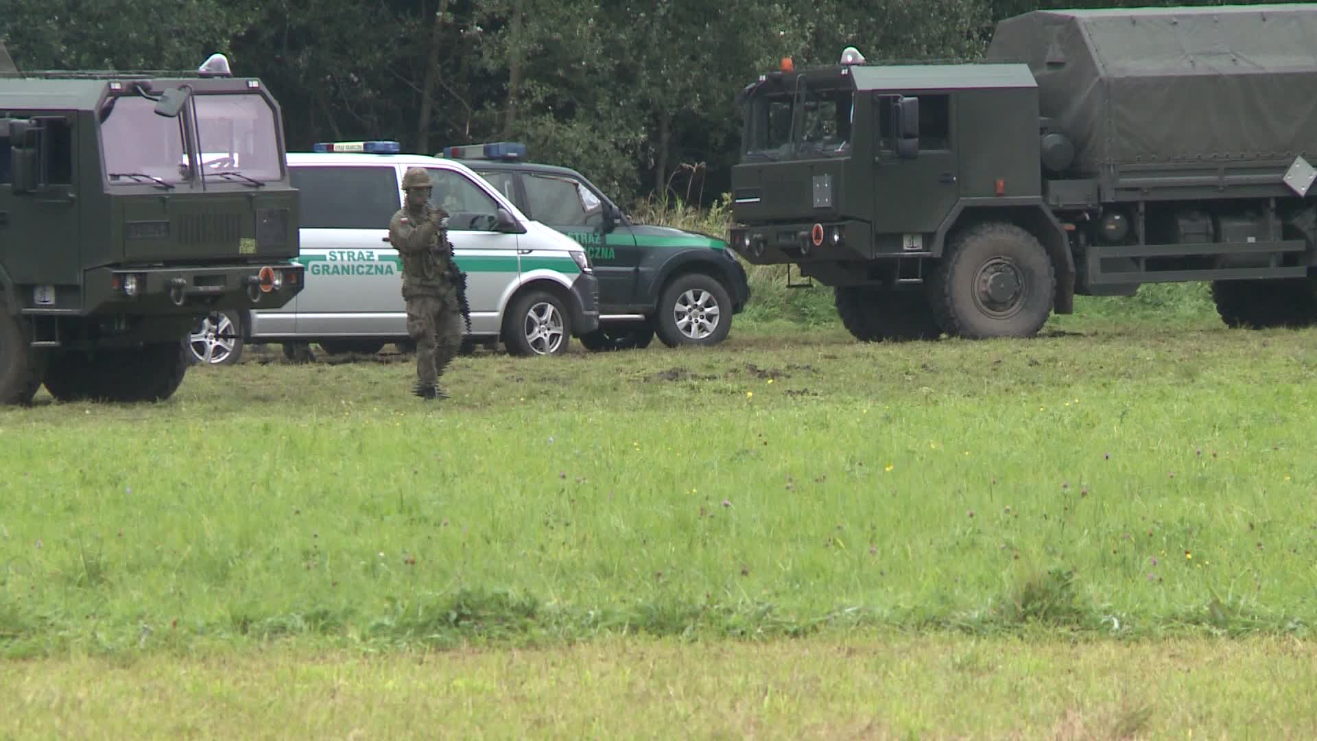 Migrants camp at Polish-Belarusian border guarded by police and military