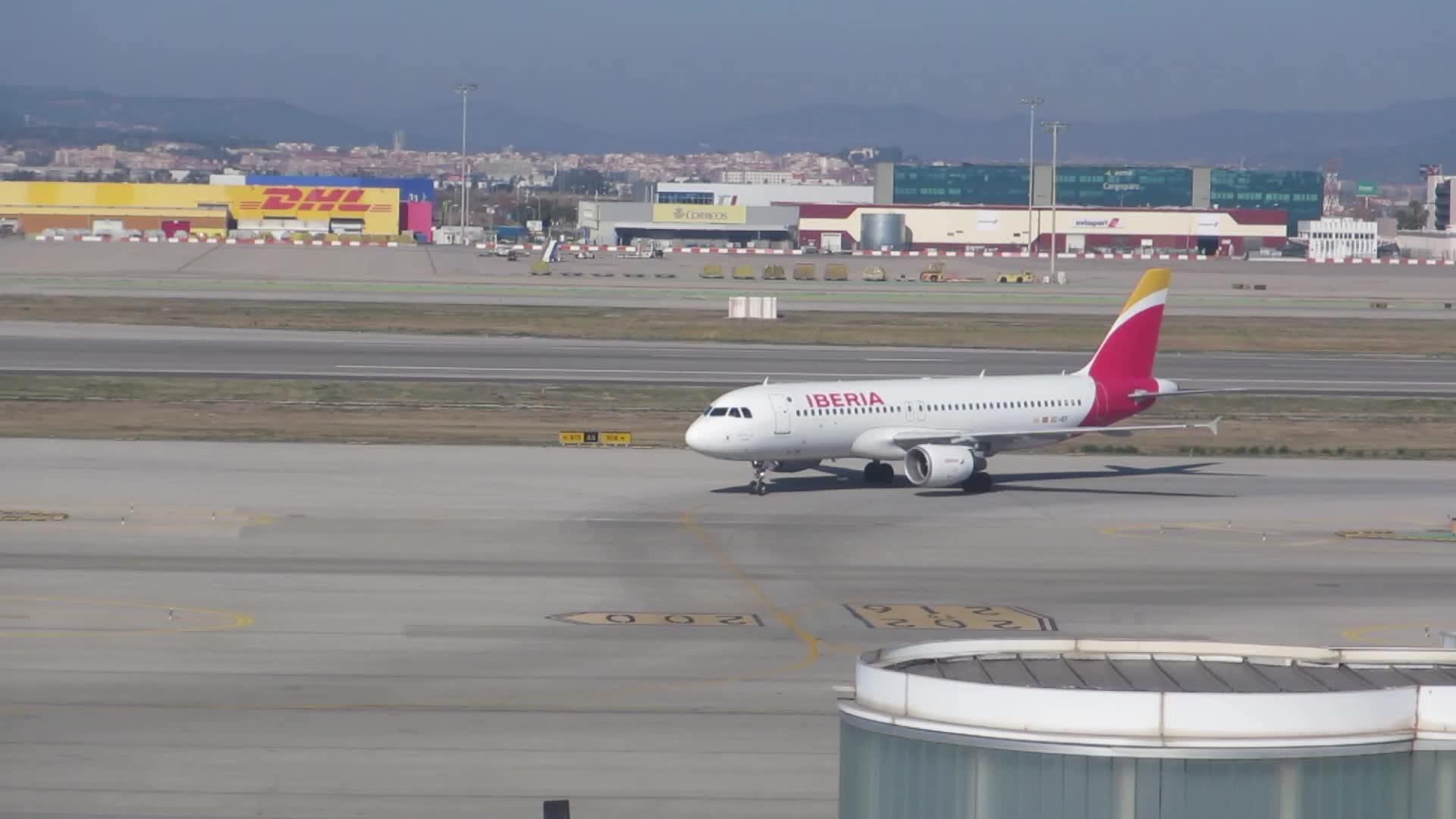 Diverse aircraft on the runway of Barcelona airport