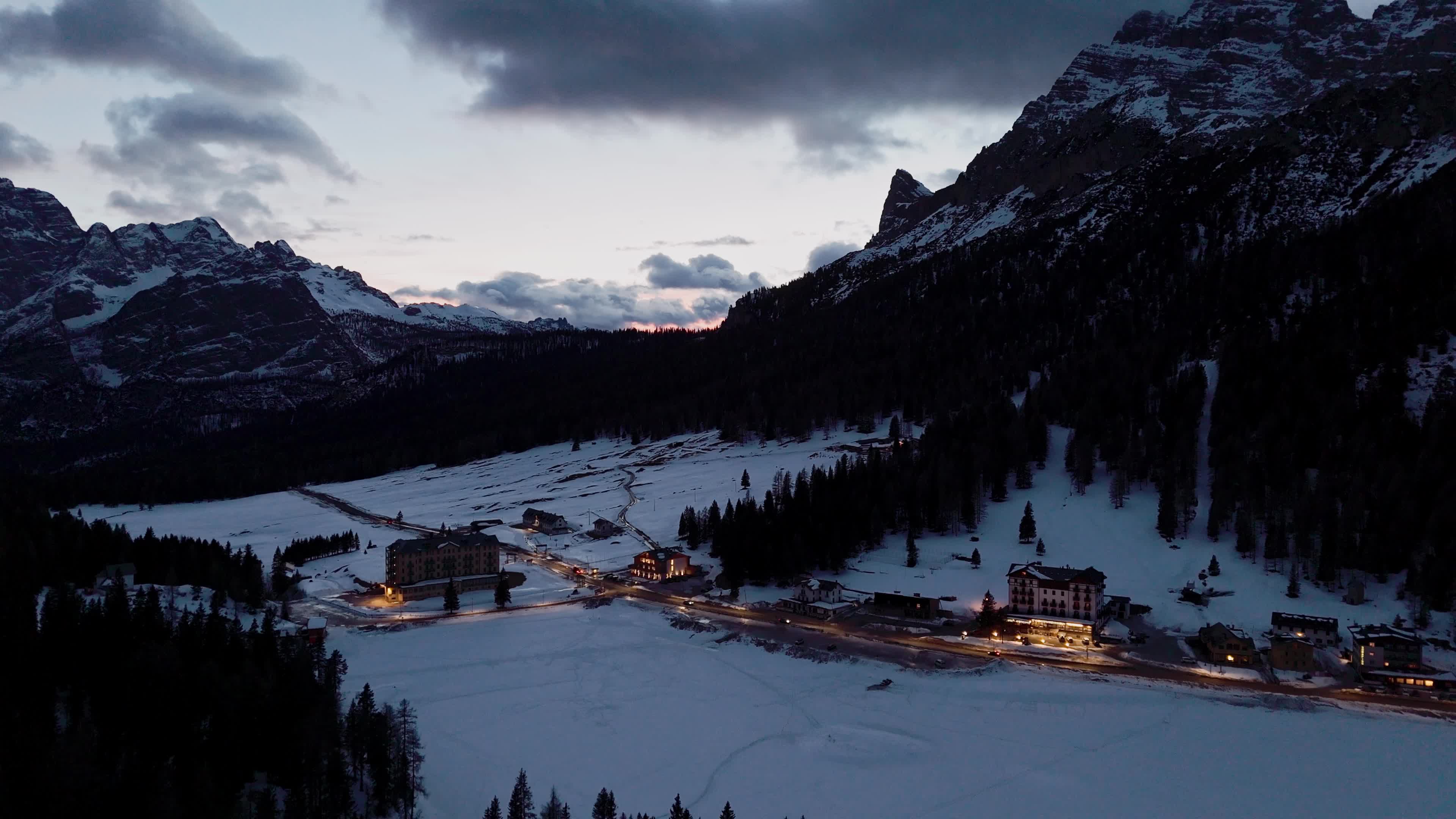 Drone View of Frozen Lake Misurina Covered in Snow At Sunset