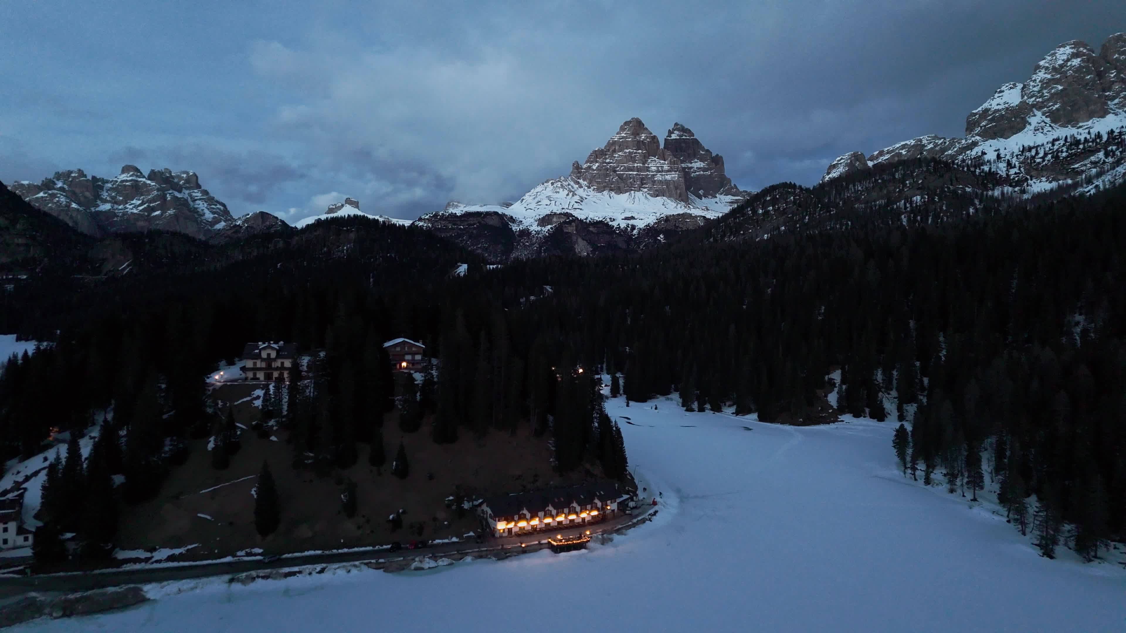 Drone View of Frozen Lake Misurina Covered in Snow At Sunset