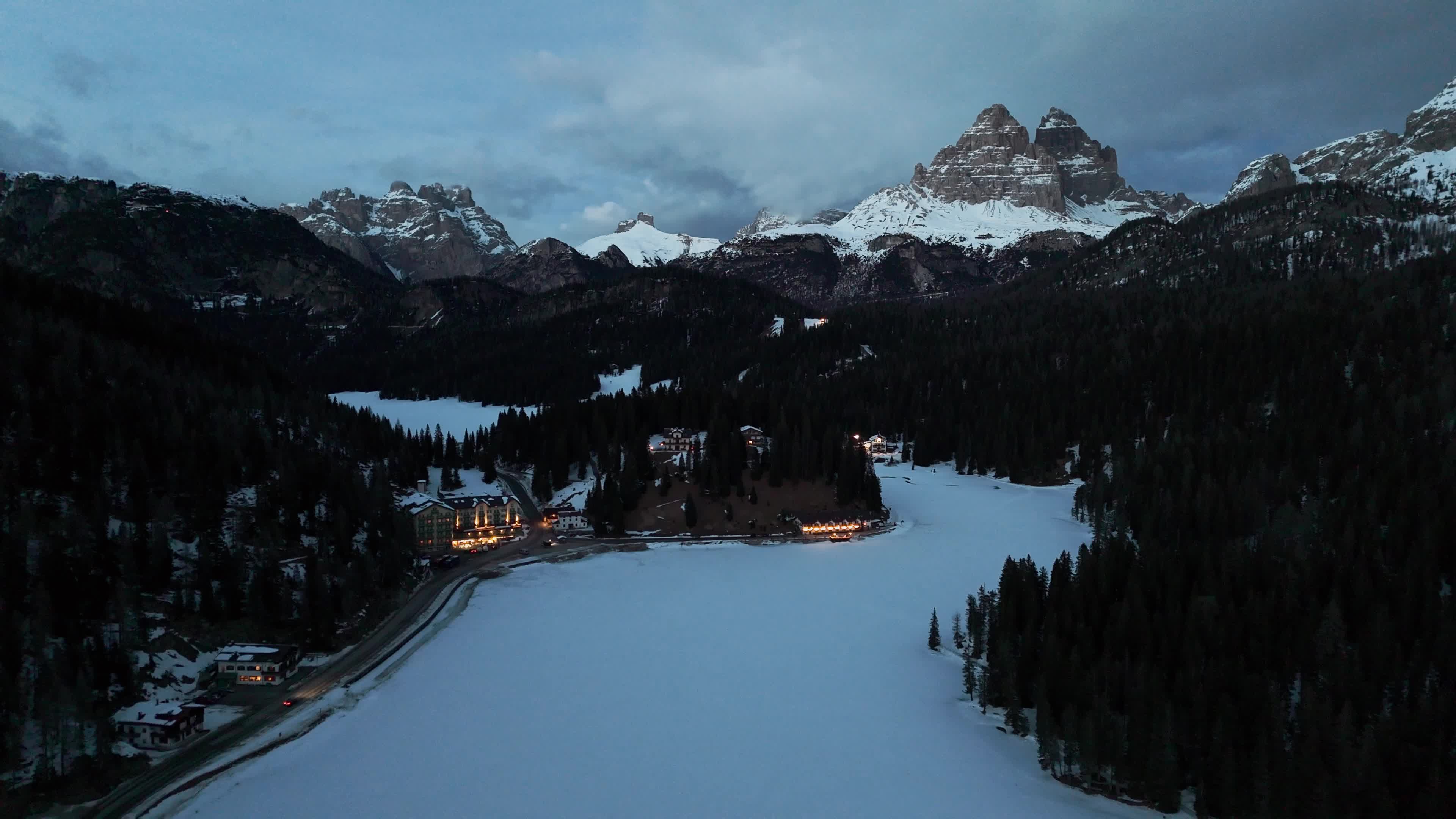 Drone View of Frozen Lake Misurina Covered in Snow At Sunset