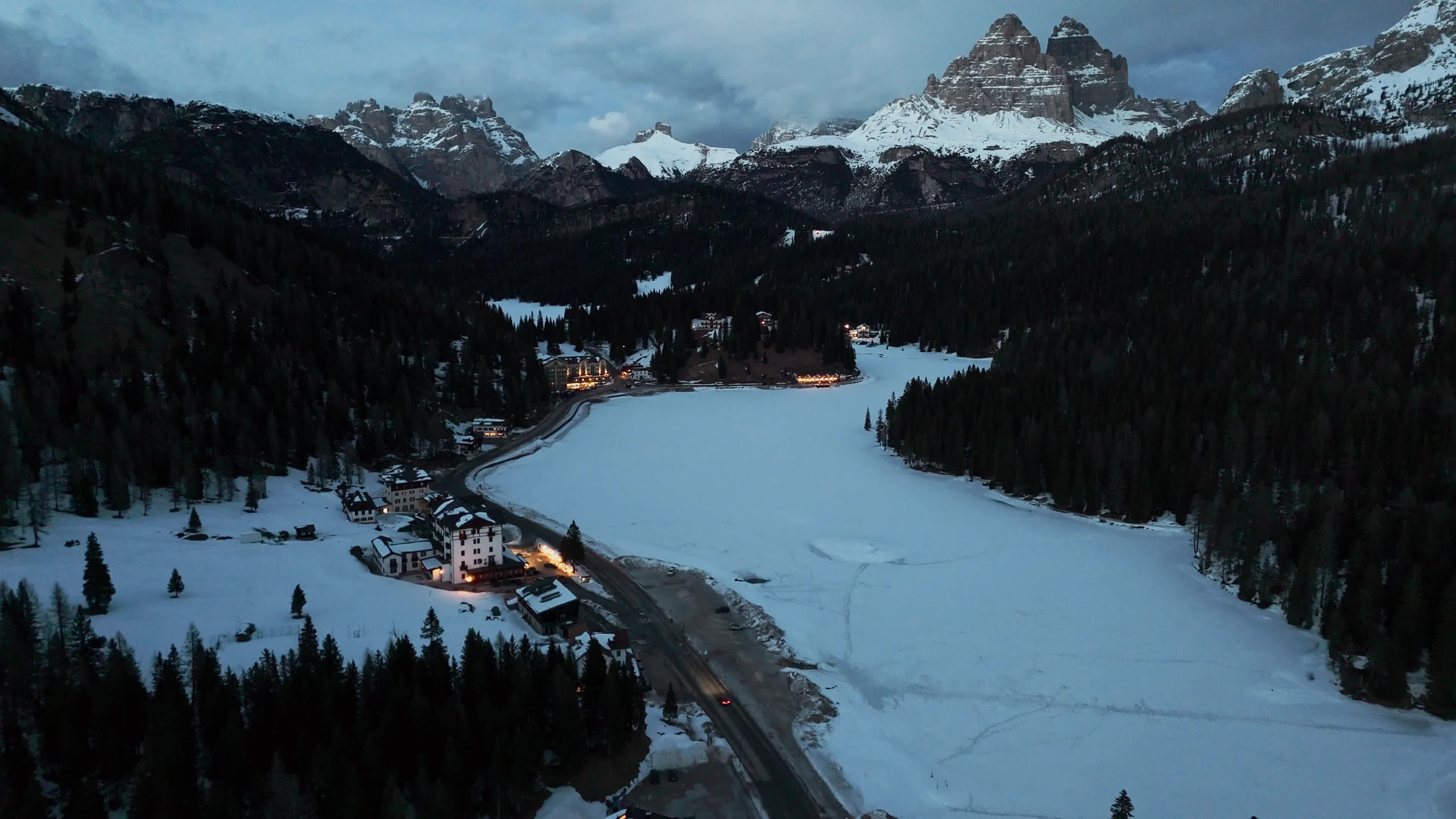 Drone View of Frozen Lake Misurina Covered in Snow At Sunset