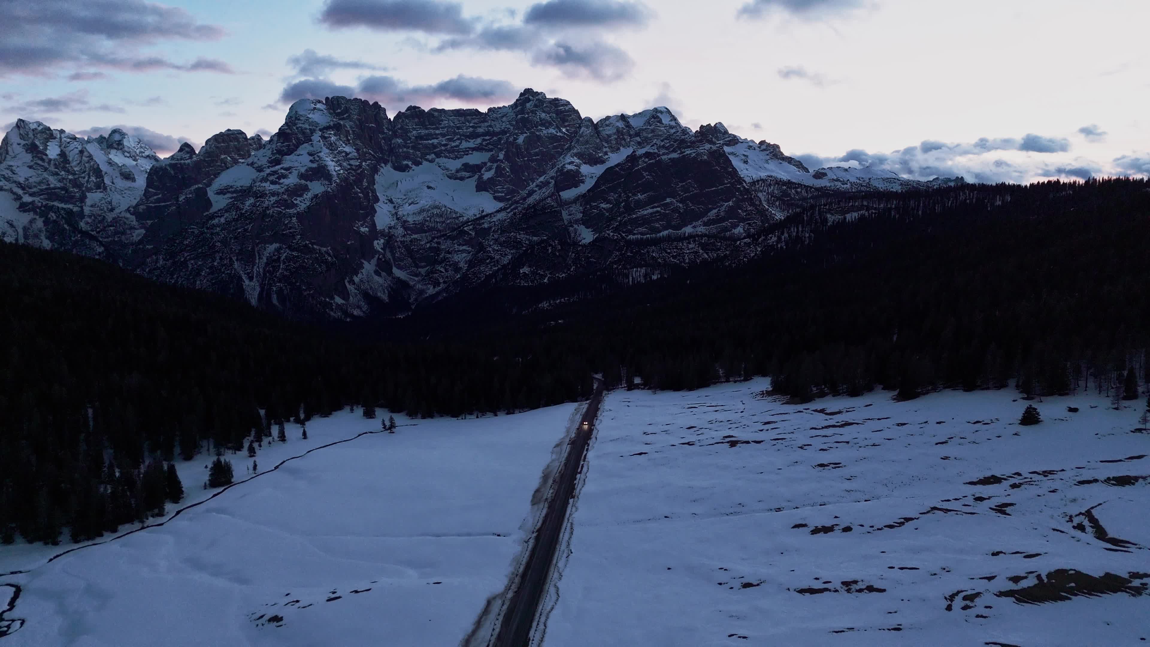 Drone View of Frozen Lake Misurina Covered in Snow At Sunset