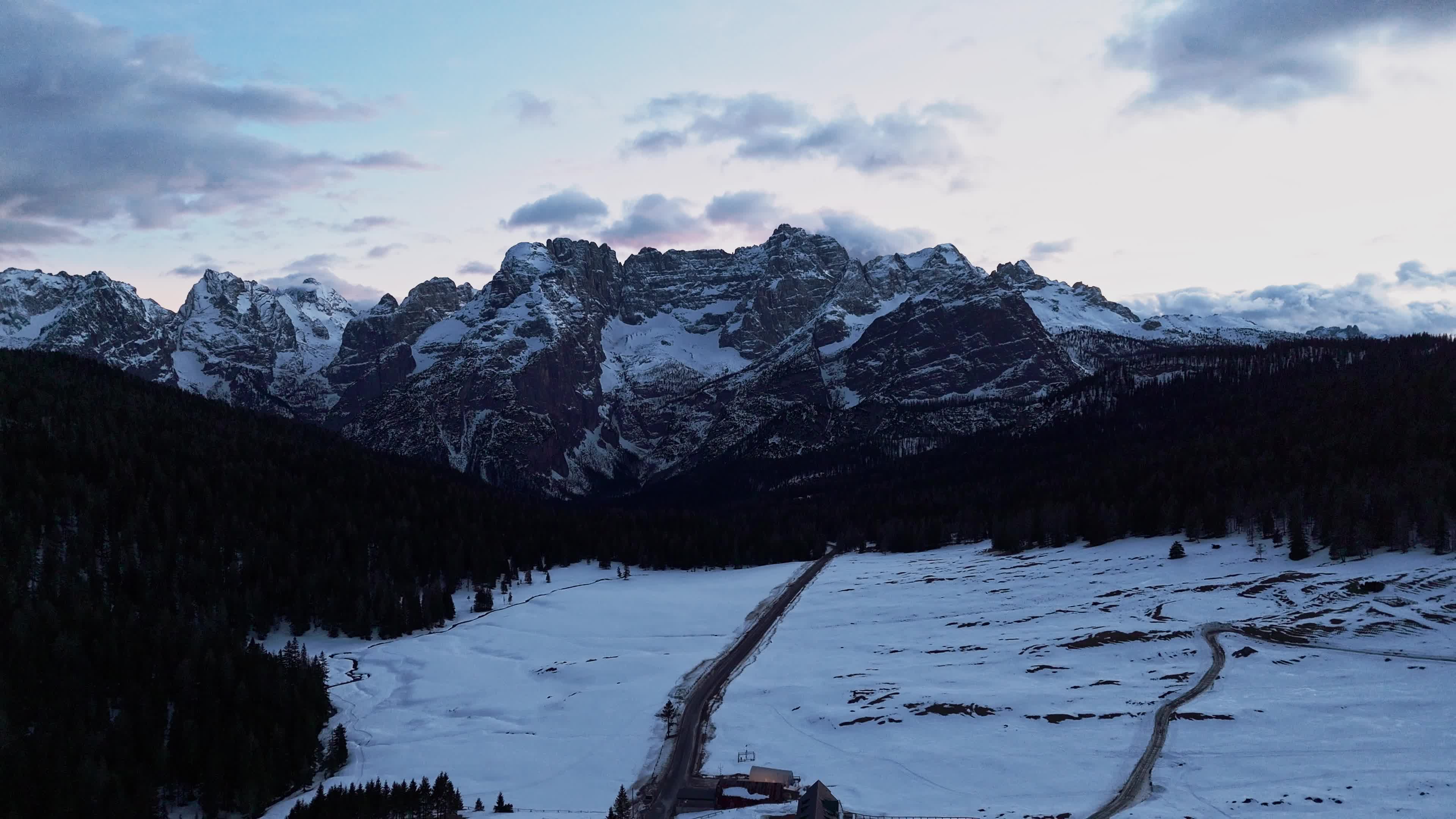 Drone View of Frozen Lake Misurina Covered in Snow At Sunset