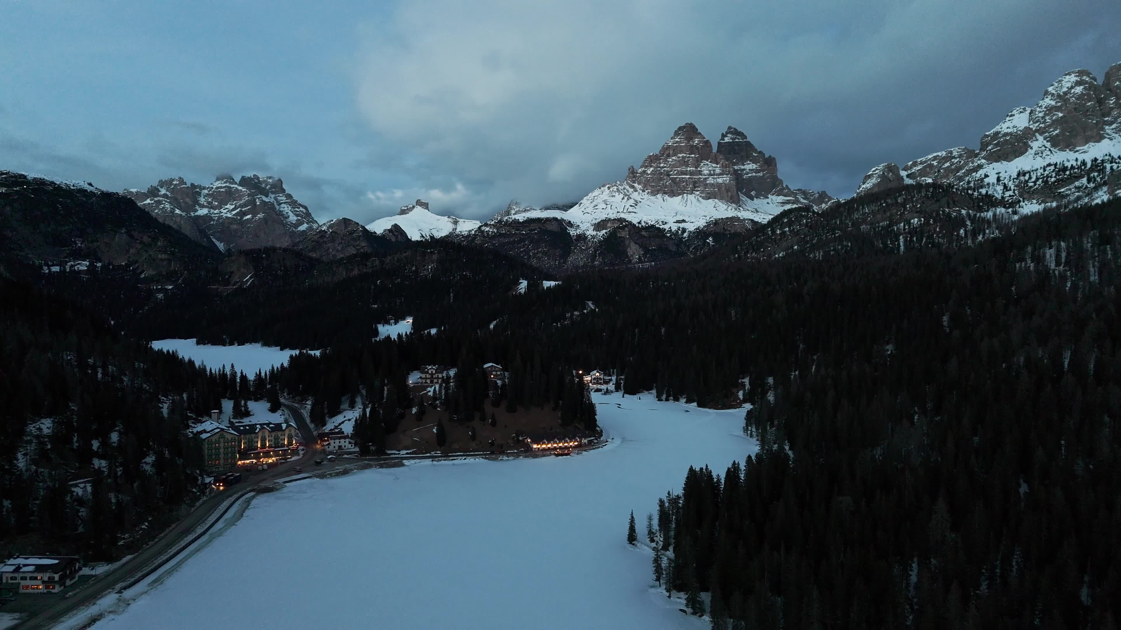 Drone View of Frozen Lake Misurina Covered in Snow At Sunset