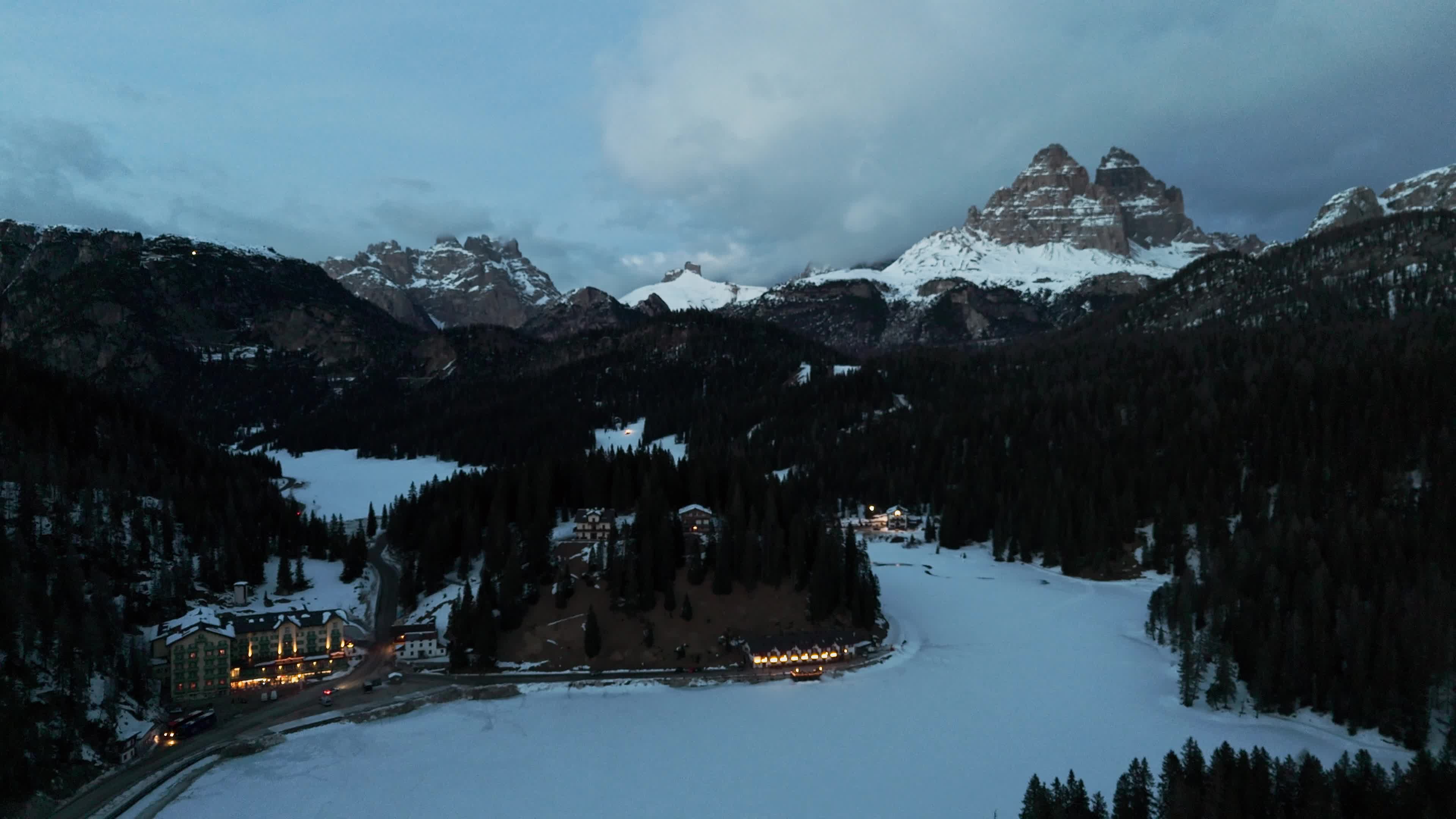 Drone View of Frozen Lake Misurina Covered in Snow At Sunset