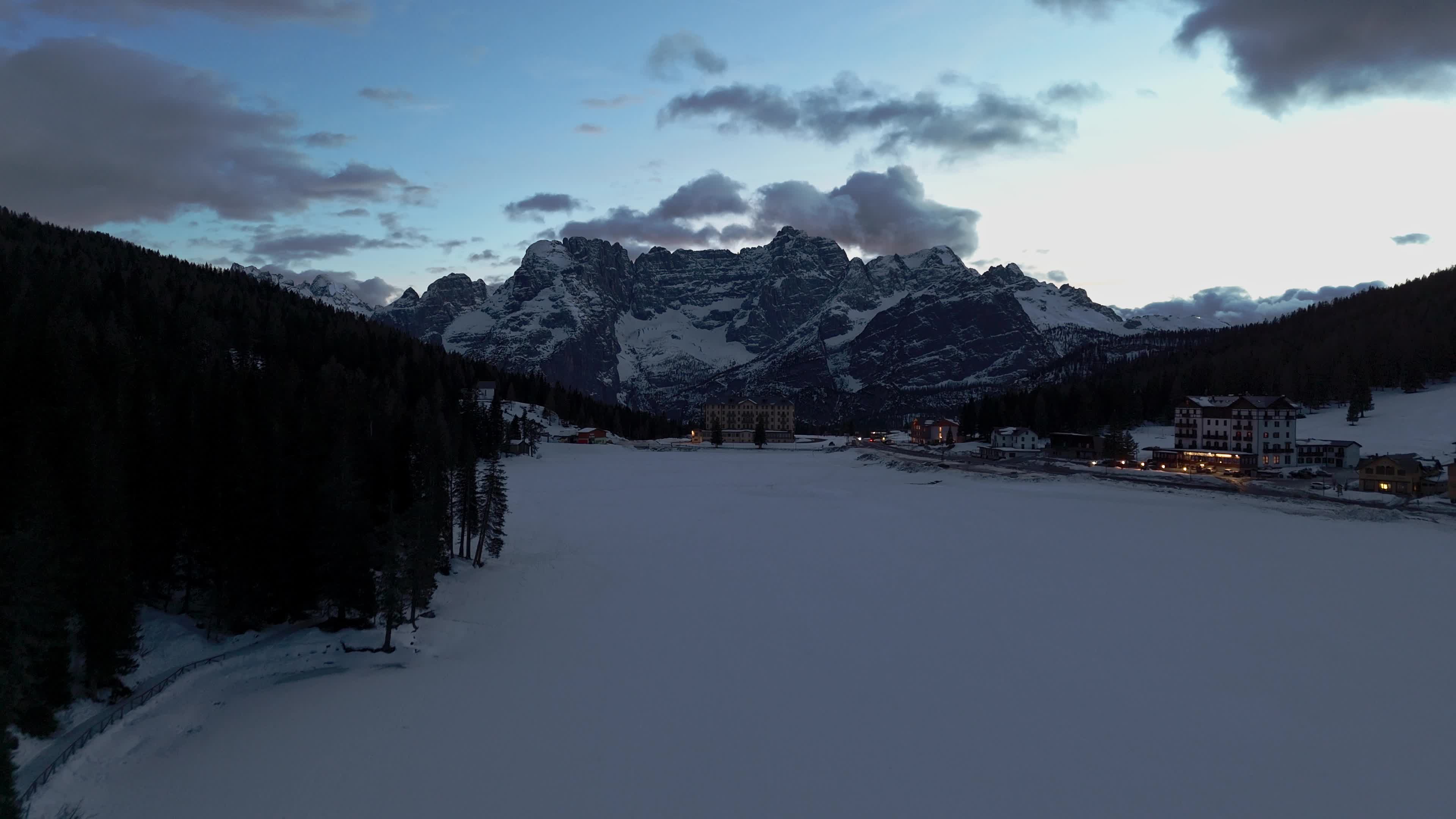 Drone View of Frozen Lake Misurina Covered in Snow At Sunset