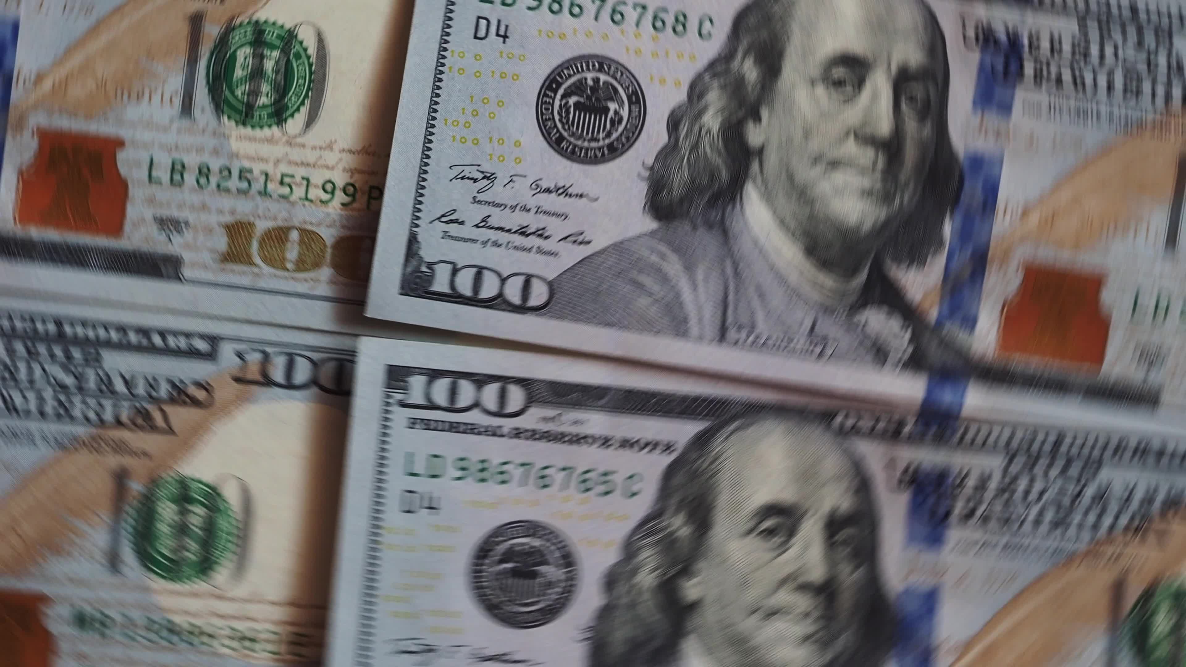 Background of rotating chaotic scattered 100 dollars bills