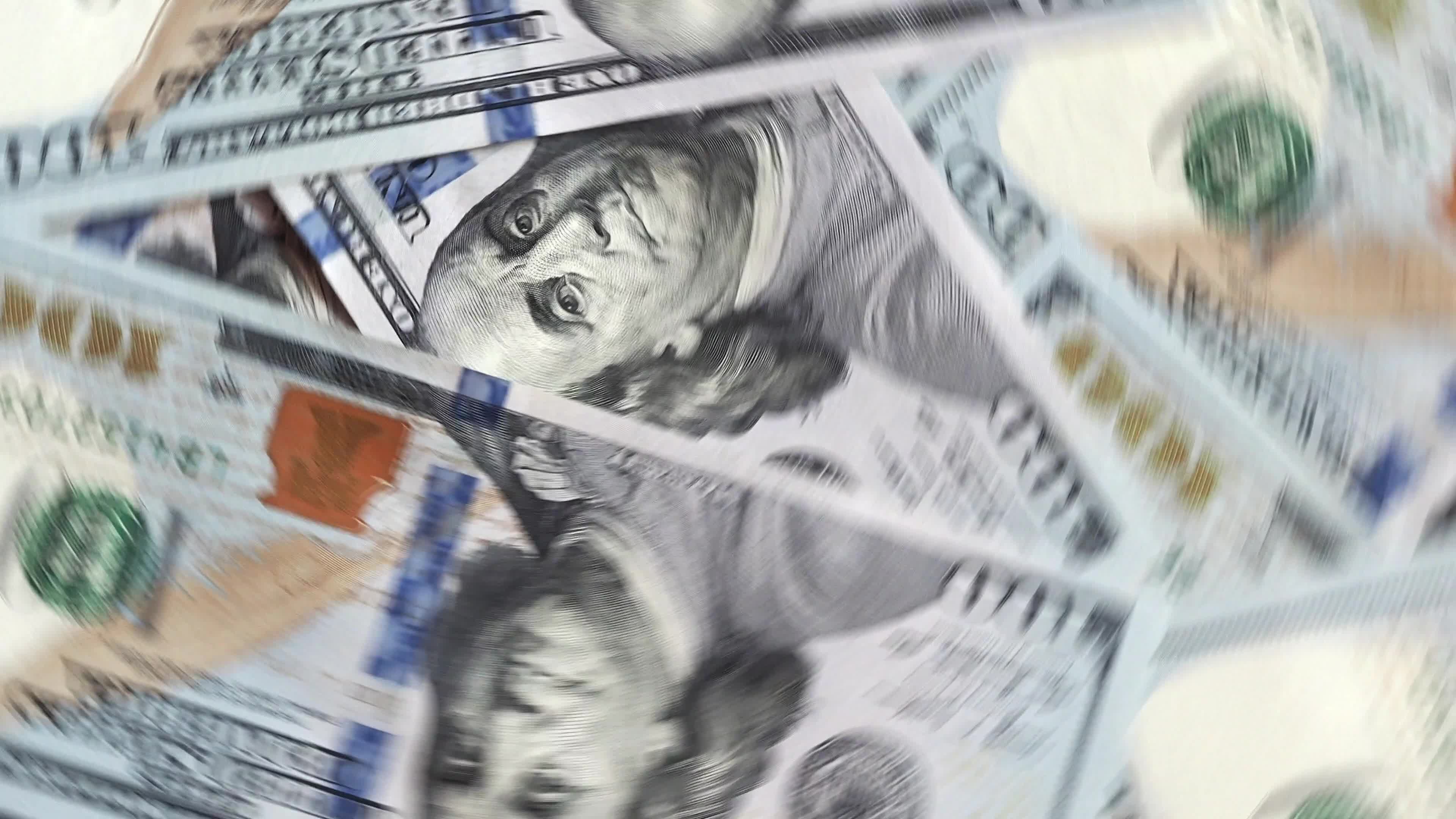 Background of rotating chaotic scattered 100 dollars bills