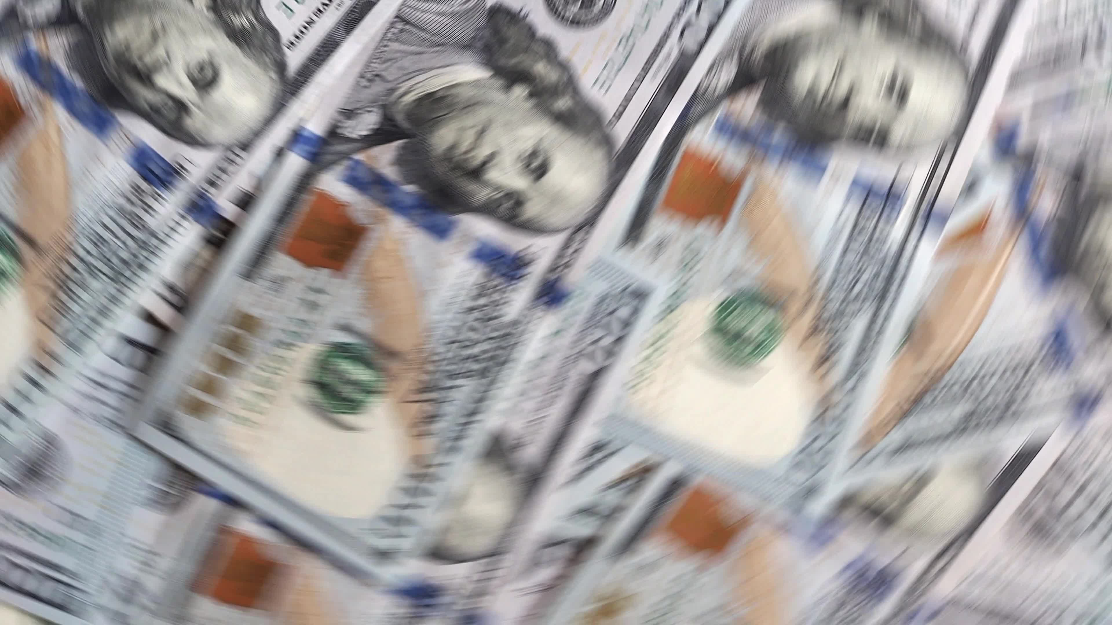 Background of rotating chaotic scattered 100 dollars bills
