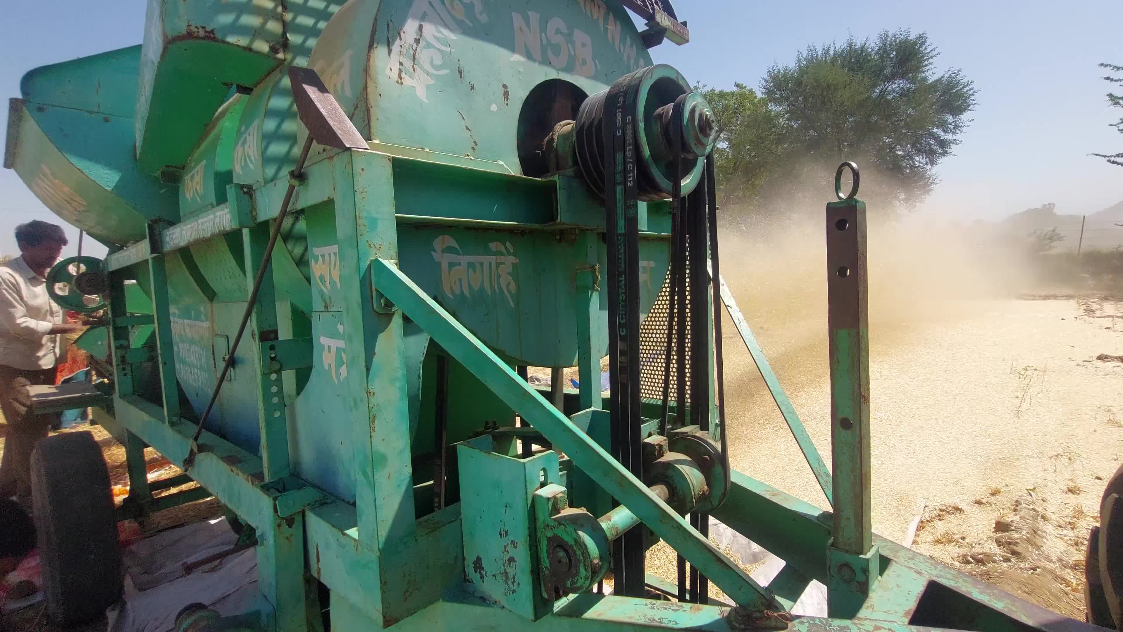 Indian Farmers thresh harvested wheat crop