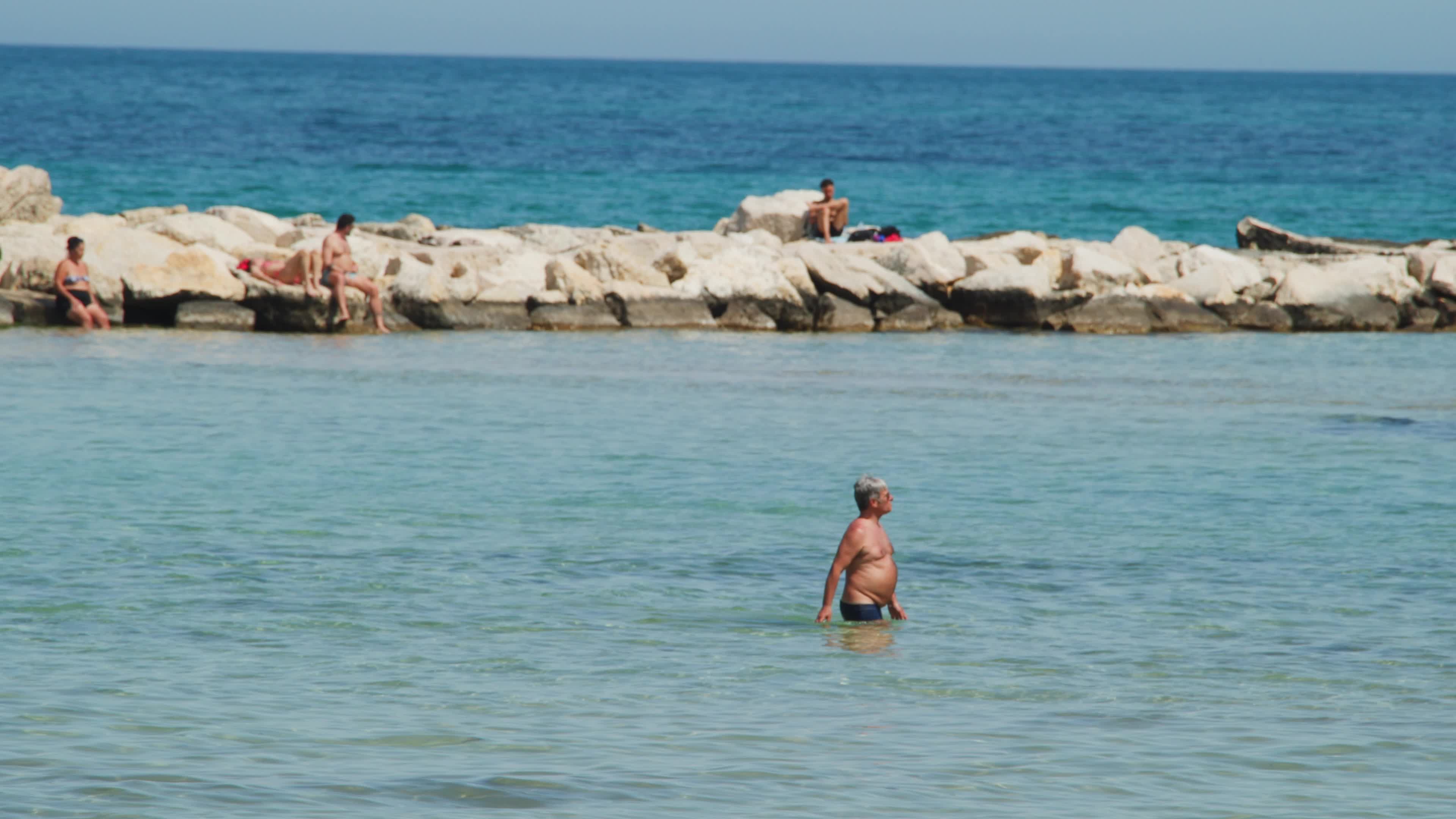 People at the Beach in Italy Amid Above-Normal Temperatures in April