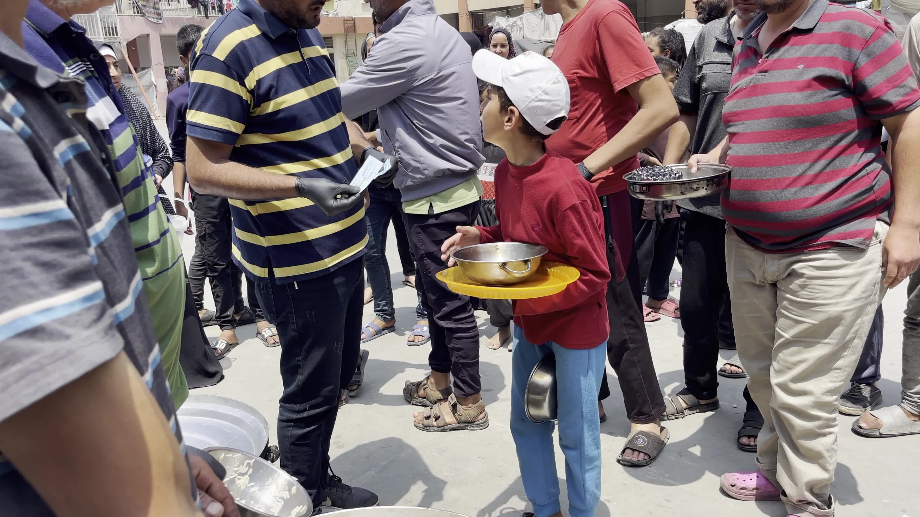 World Central Kitchen Aid Worker Serves Meals to Palestinians Amid Hamas-Israel Conflict