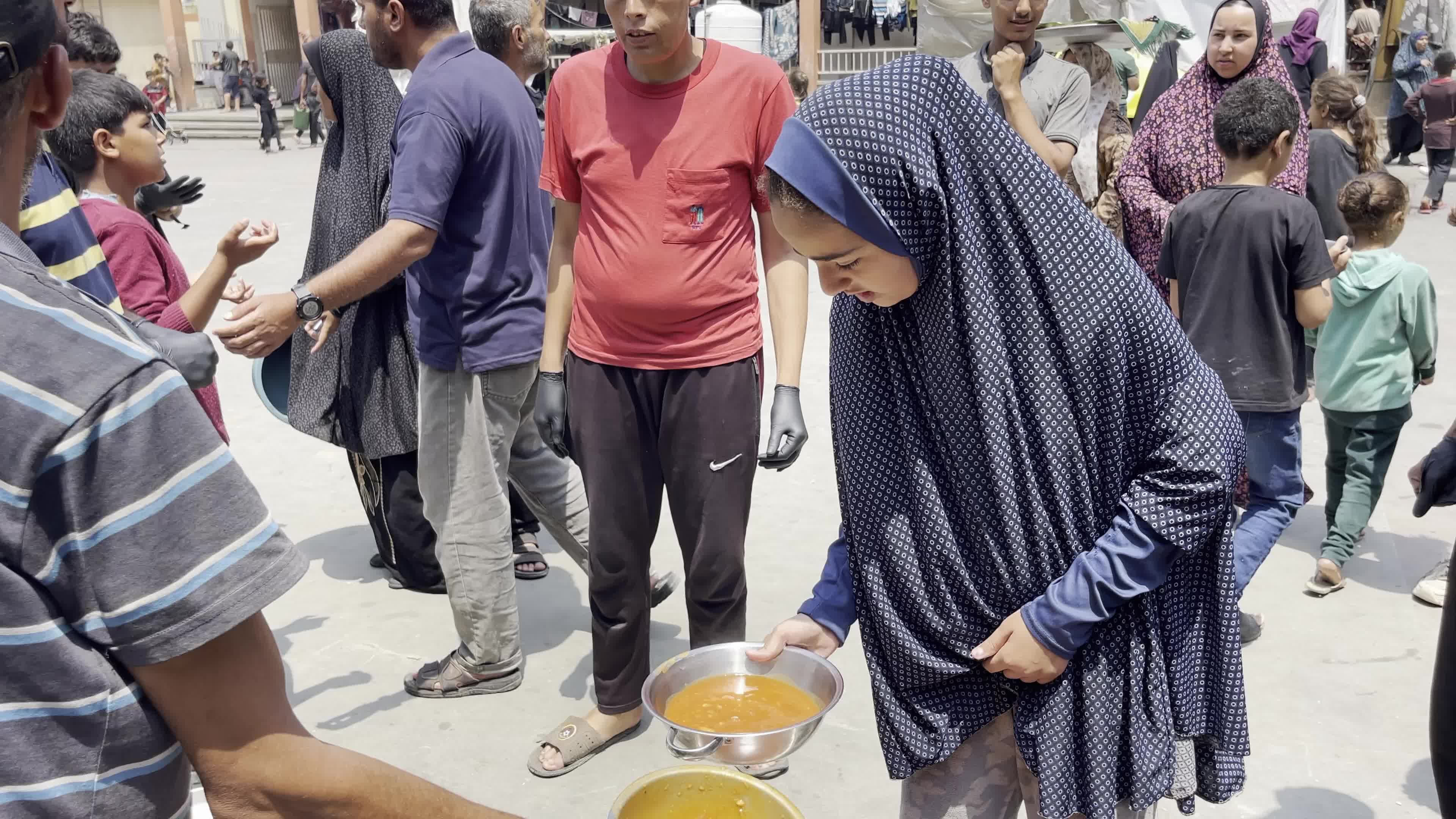 World Central Kitchen Aid Worker Serves Meals to Palestinians Amid Hamas-Israel Conflict