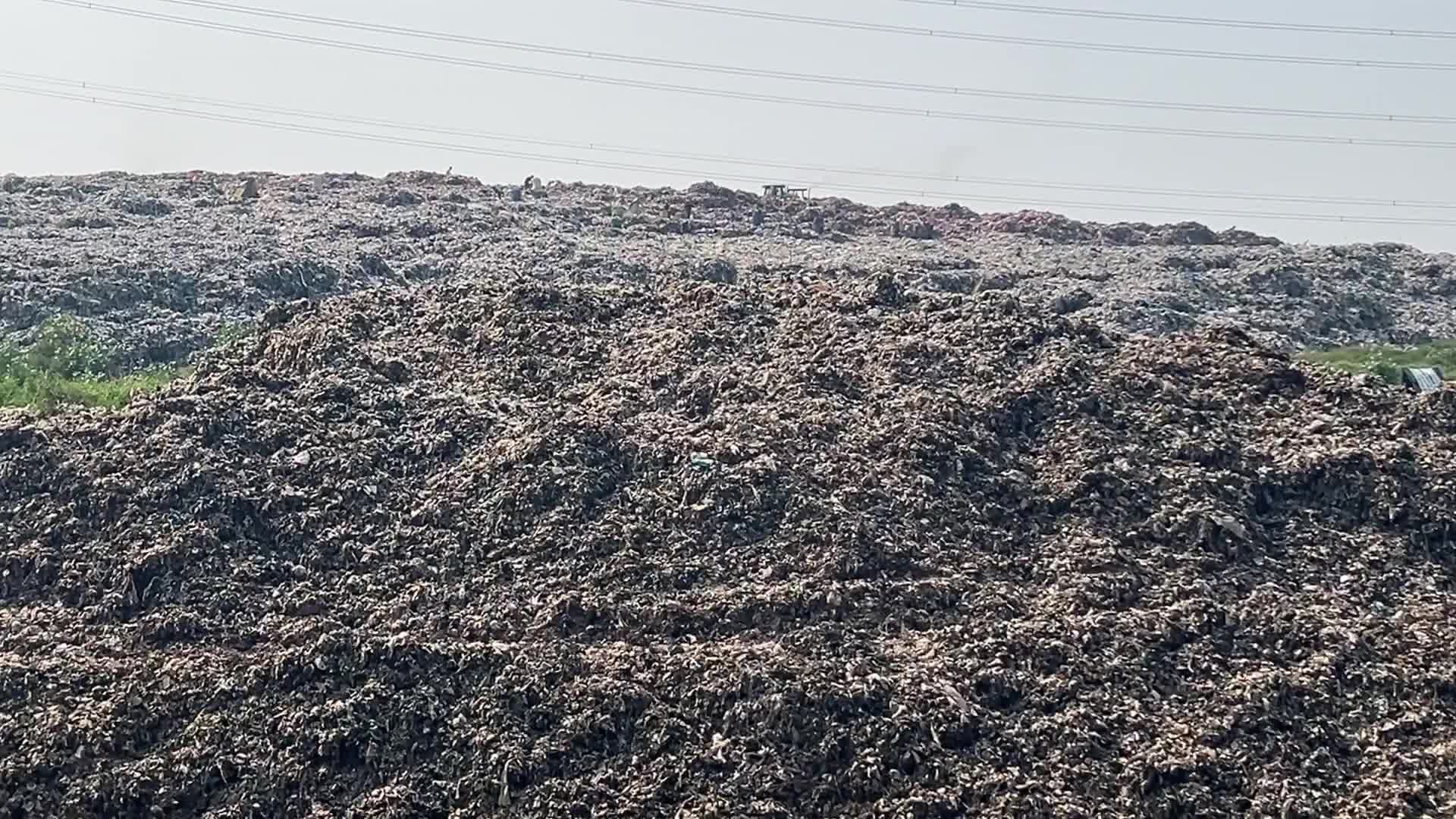 Hill of Garbage waste and poluted river in Indonedia